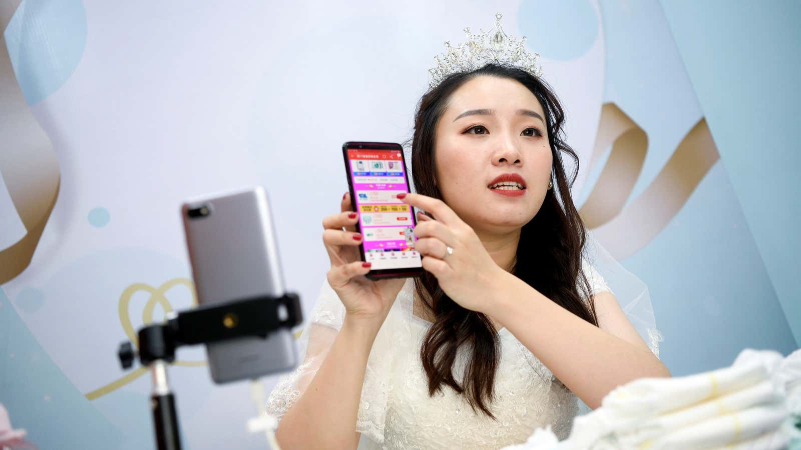 A live-streaming anchor wearing a wedding gown promotes Pampers baby diapers through a live streaming session on the eve of the 11.11 Singles’ Day shopping…