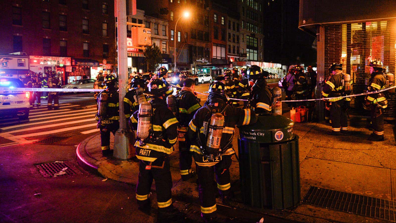 New York City firefighters stand near the site of an explosion in the Chelsea neighborhood of Manhattan, New York.