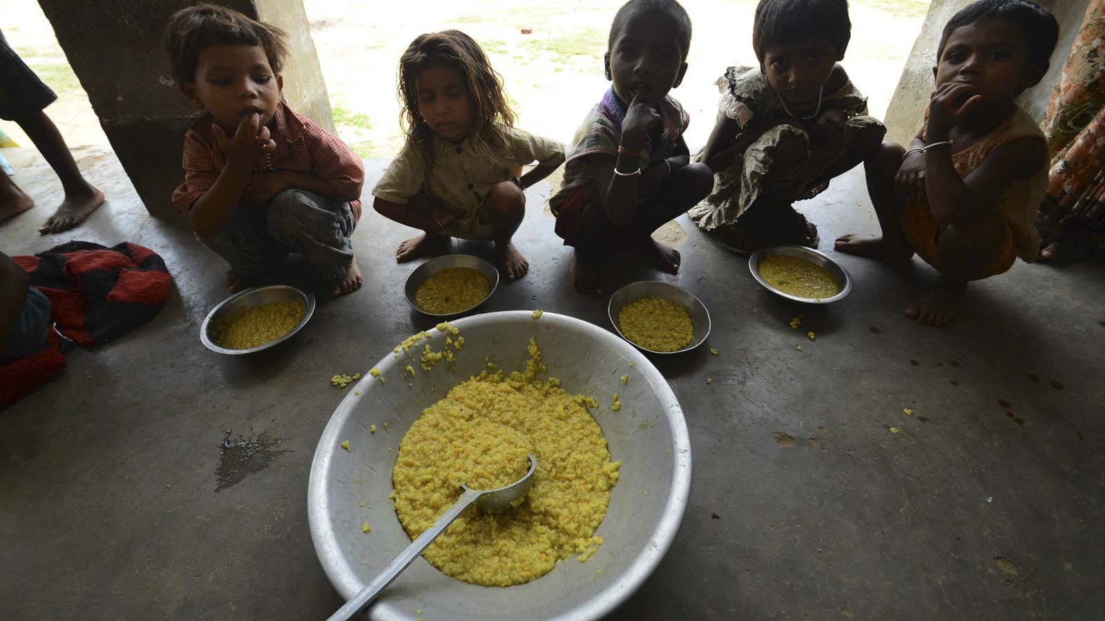 Children in Bihar, India eat a free school lunch.