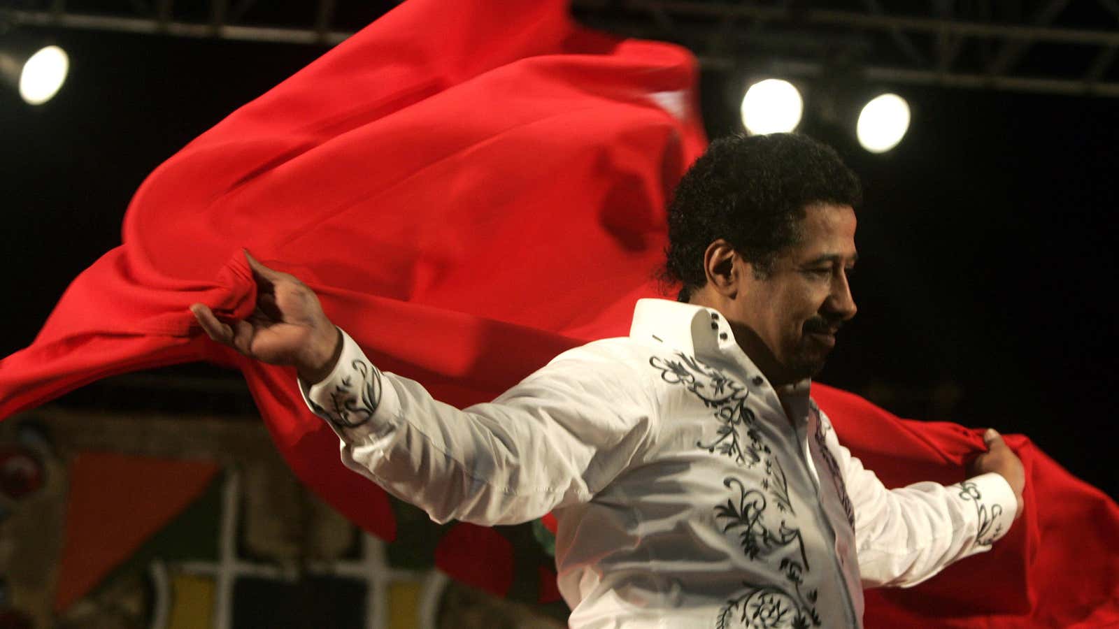 Algerian singer Cheb Khaled, often called King of Rai, covers himself with a Moroccan flag during a 2009 concert.