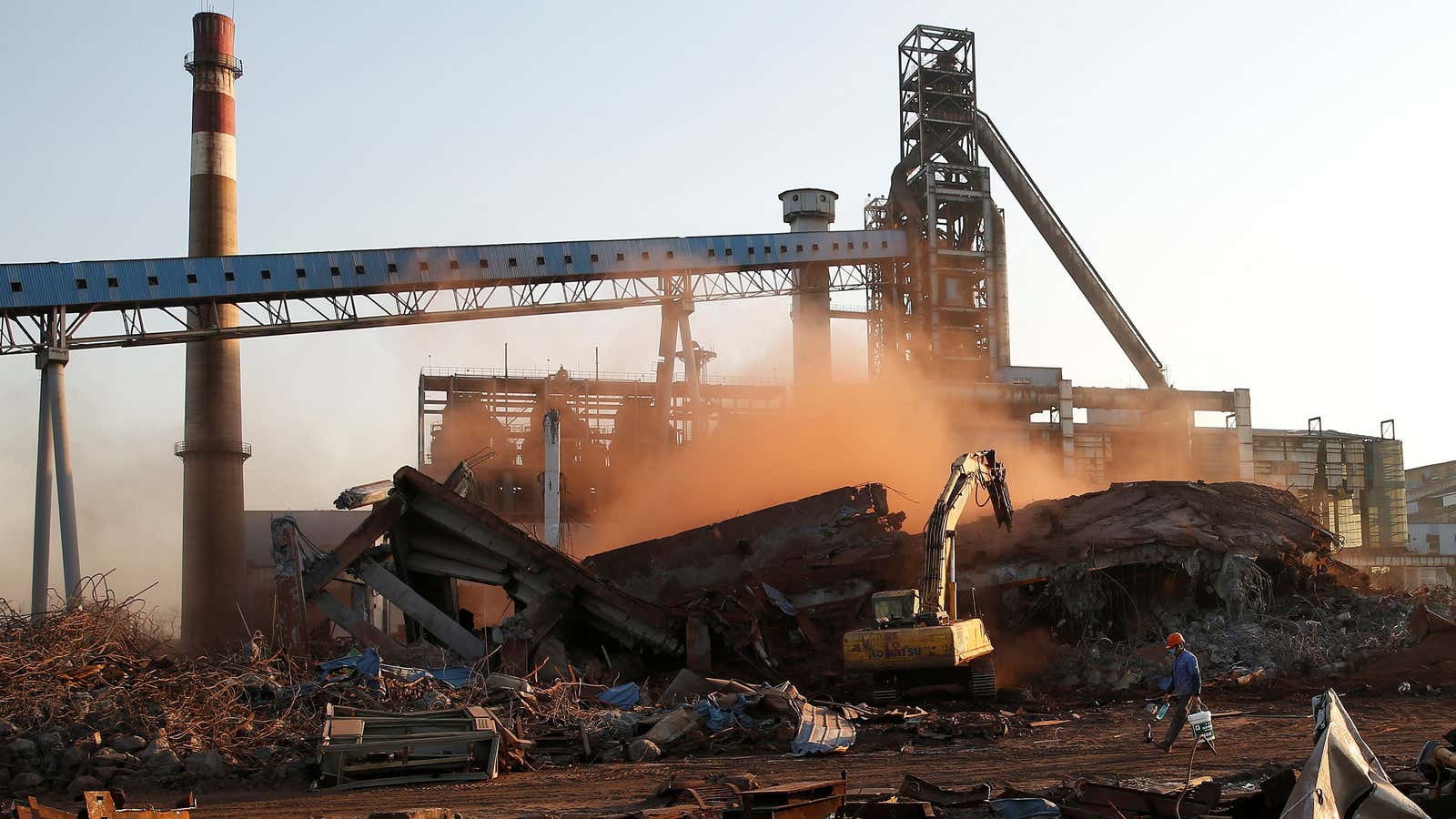 A worker walks at a demolished quarter at a steel plant of Hangzhou Iron&amp;Steel Group company, which was shut down as part of the city’s…