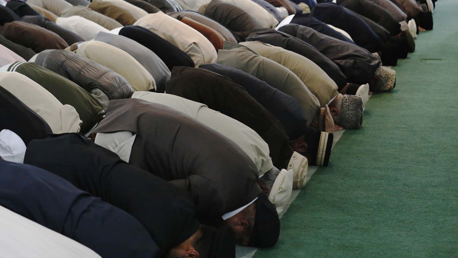 Men pray at the Baitul Futuh Mosque in Morden, south London.