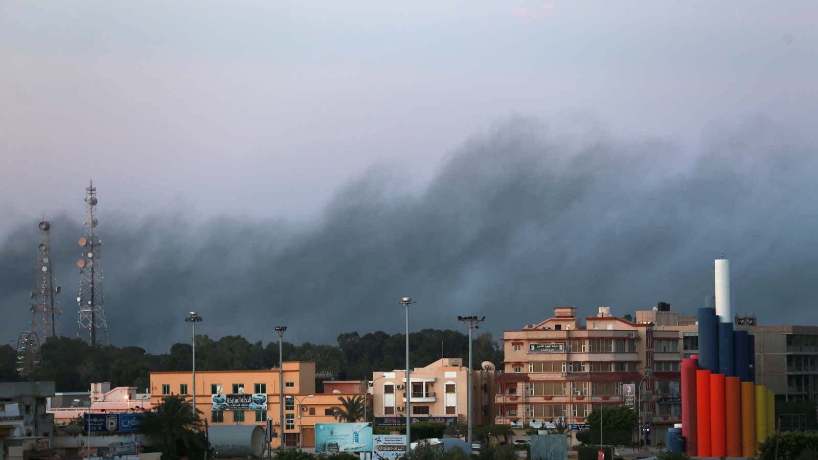 Smoke hovers over clashes in Benghazi, Libya. US policy toward the North African country has made it an even more active hub for Islamist terror.