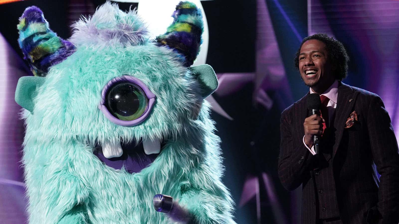 Host Nick Cannon standing next to the “monster.”