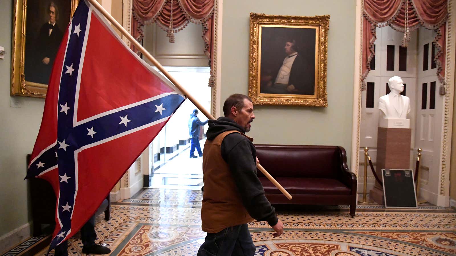 A Trump supporter carries a Confederate flag inside the US Capitol