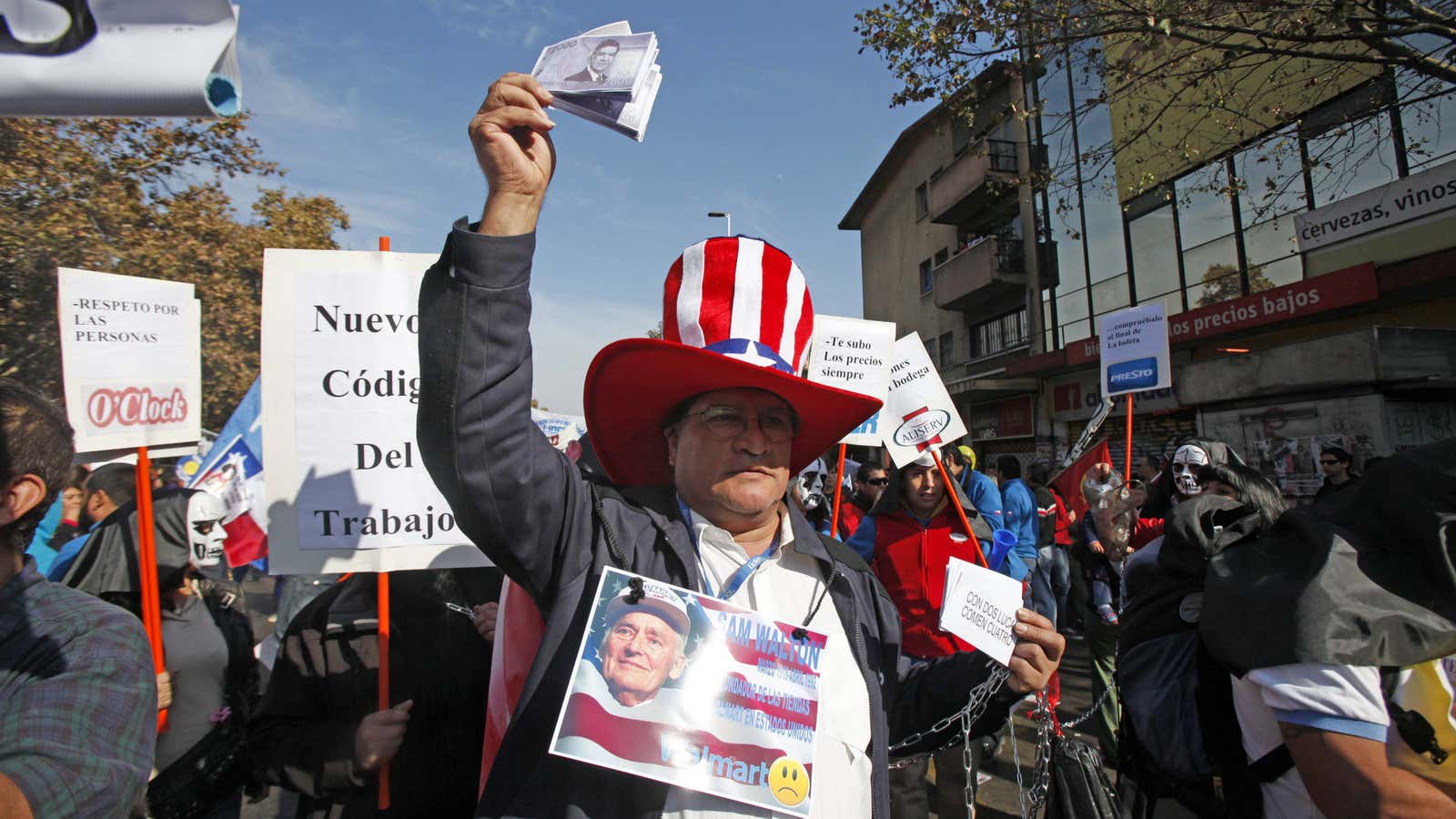 A protester in Chile dresses  like Uncle Sam and holds up fake money. The recent selloff does not treat some currencies—including Chile’s—as more “virtuous” than others.