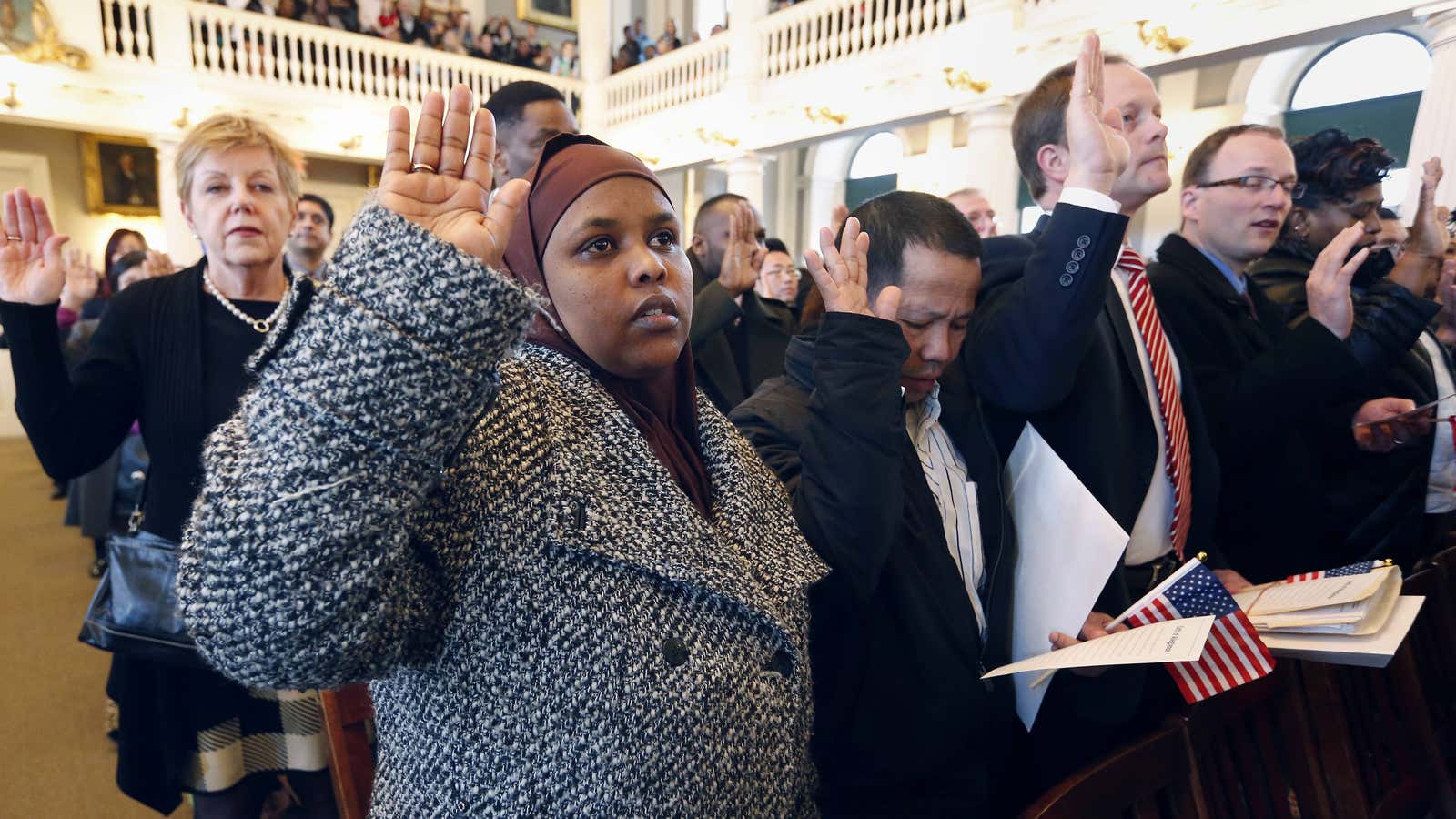 Hawd Ahmed, front left, who came from Somalia, takes the oath of US citizenship during a 2015 naturalization ceremony.