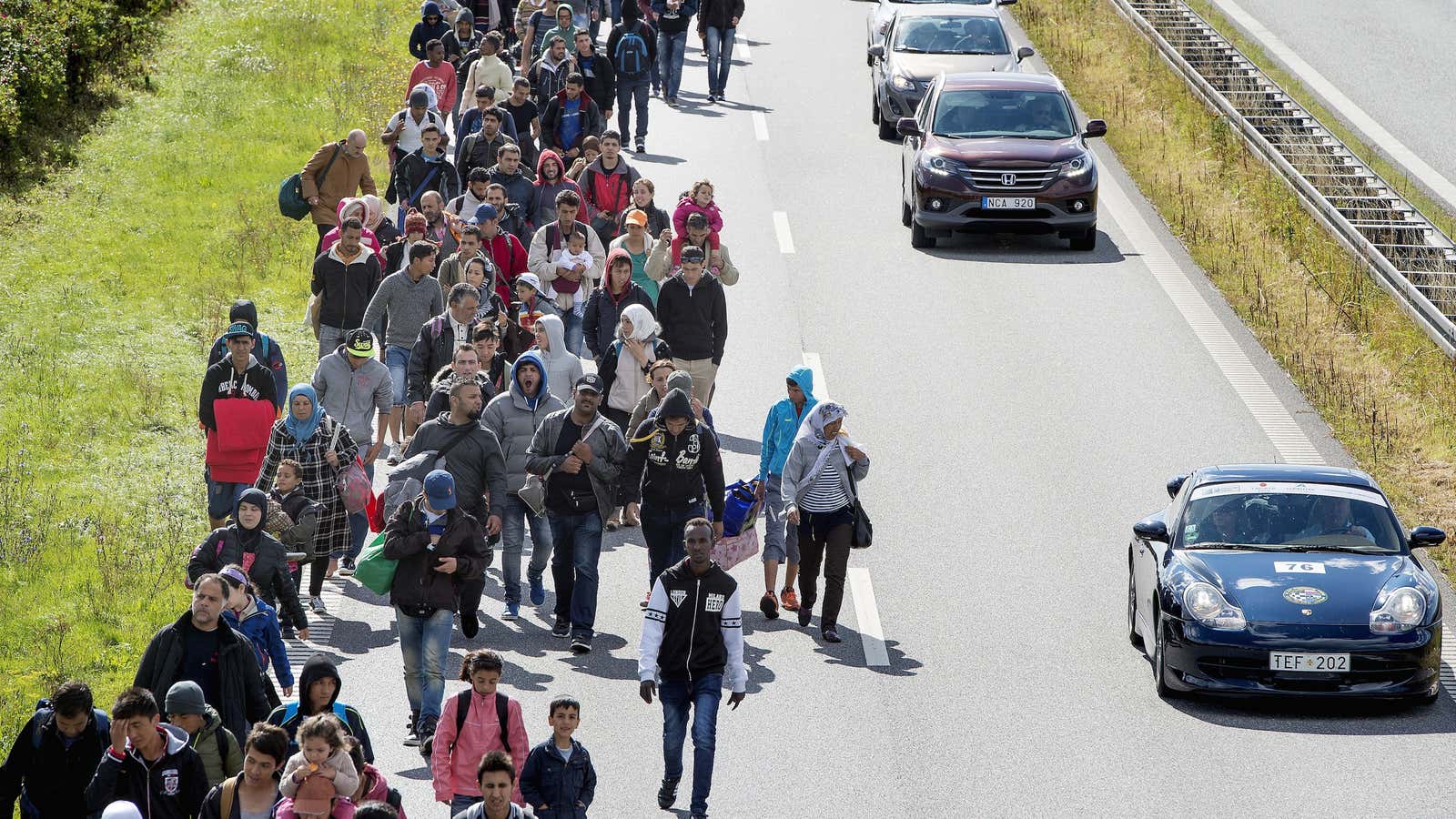 Migrants stream northward on a Danish highway.