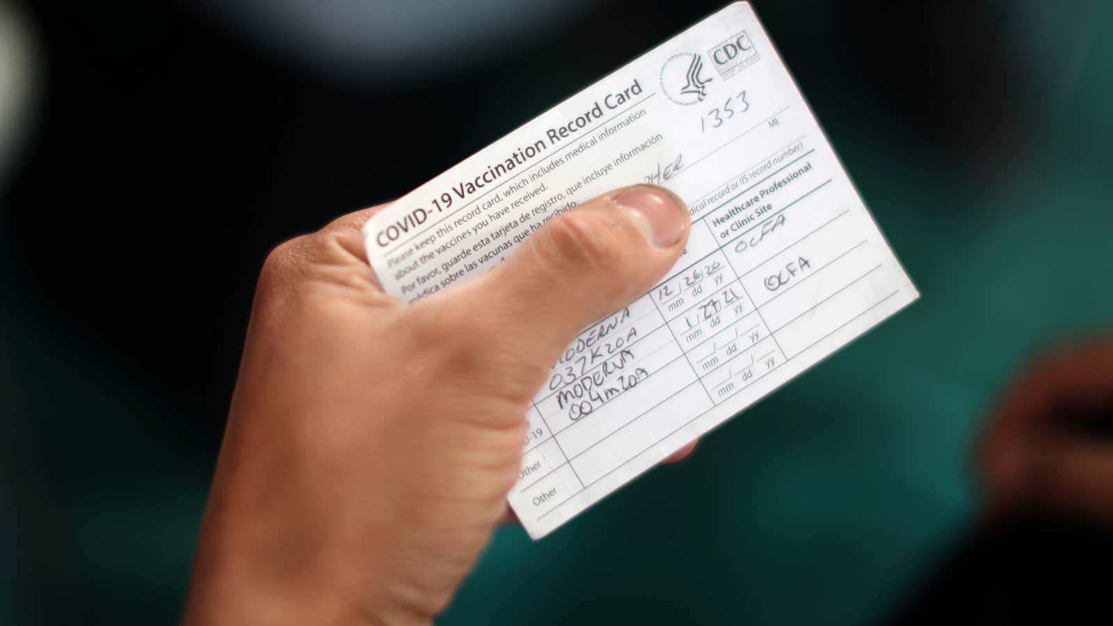 An Orange County firefighter holds his vaccination card after receiving the coronavirus disease (COVID-19) vaccine in Irvine, California, U.S., January 27, 2021.