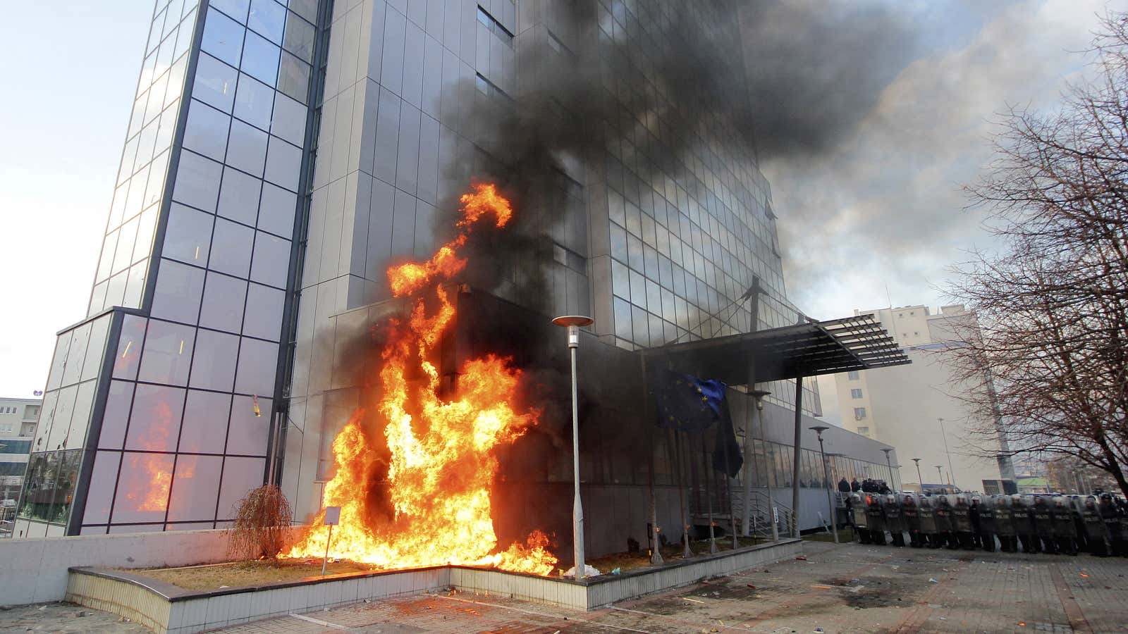 A portion of the national government headquarters in Pristina, Kosovo, burns.