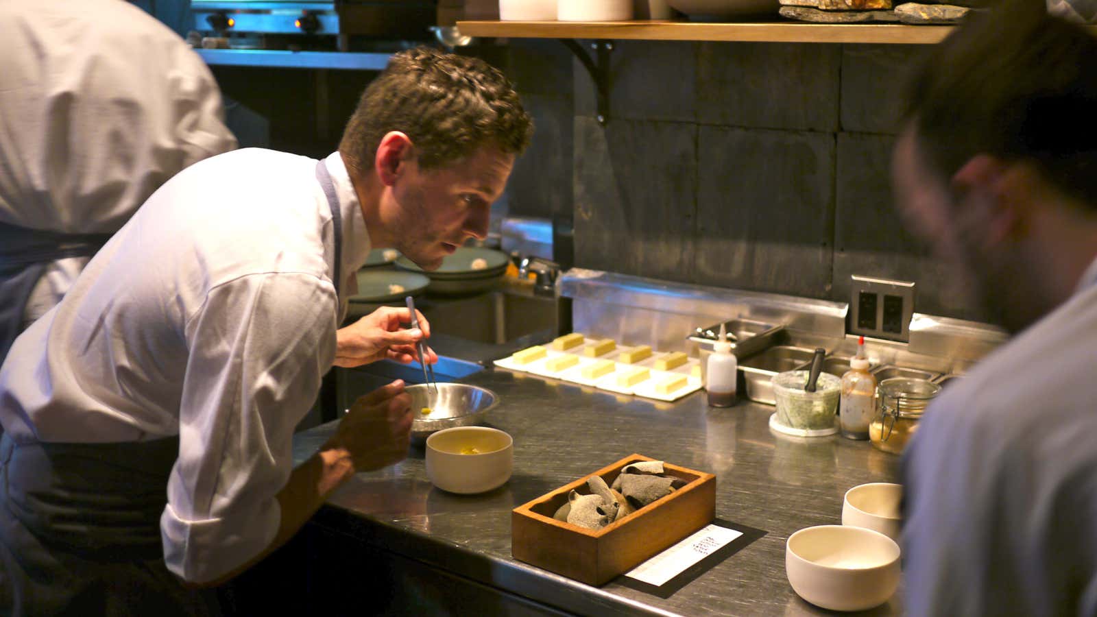 Jacob Nemmers, Atera cook, using tweezers to plate peeky-toe crab and artichokes.