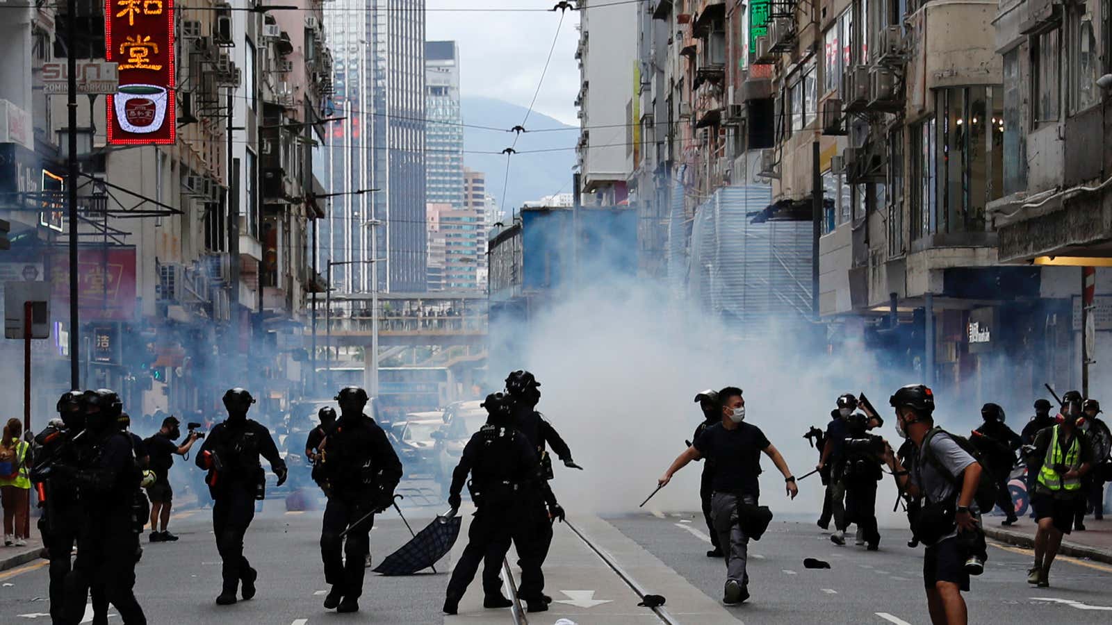 Riot police fire tear gas into the crowds to disperse anti-national security law protesters during a march at the anniversary of Hong Kong’s handover to…