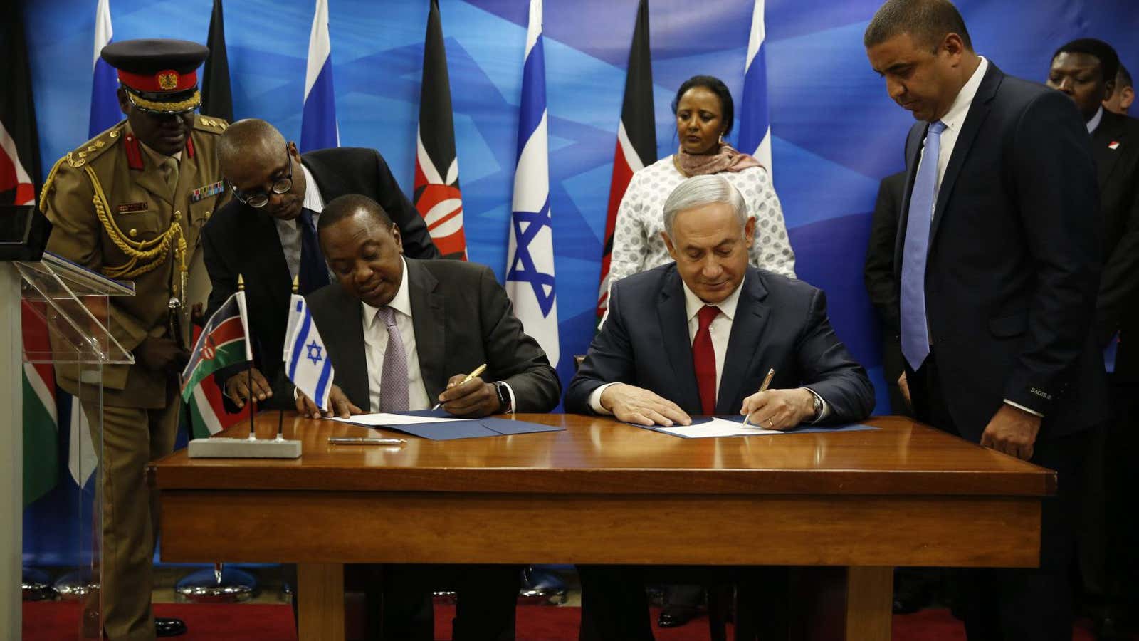 Kenyan president, Uhuru Kenyatta, and Israeli prime minister, Benjamin Netanyahu, sign agreements after they delivered joint statements in Jerusalem on Feb. 23, 2016.