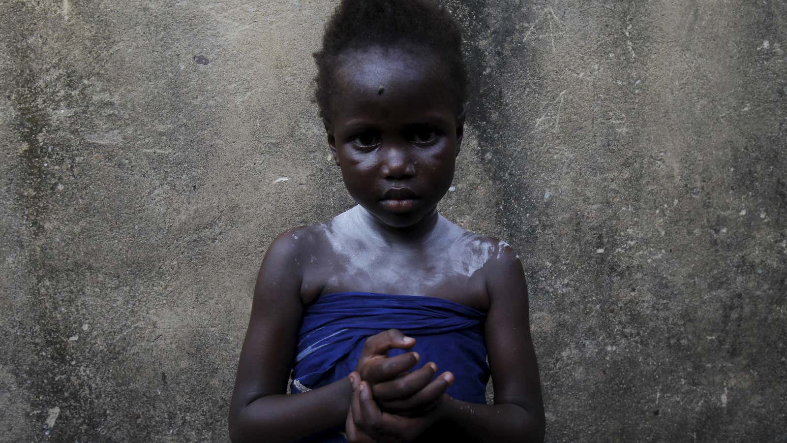 Mariam Tchinda, 6, stands at her home in Cocody Danga slum in Abidjan.