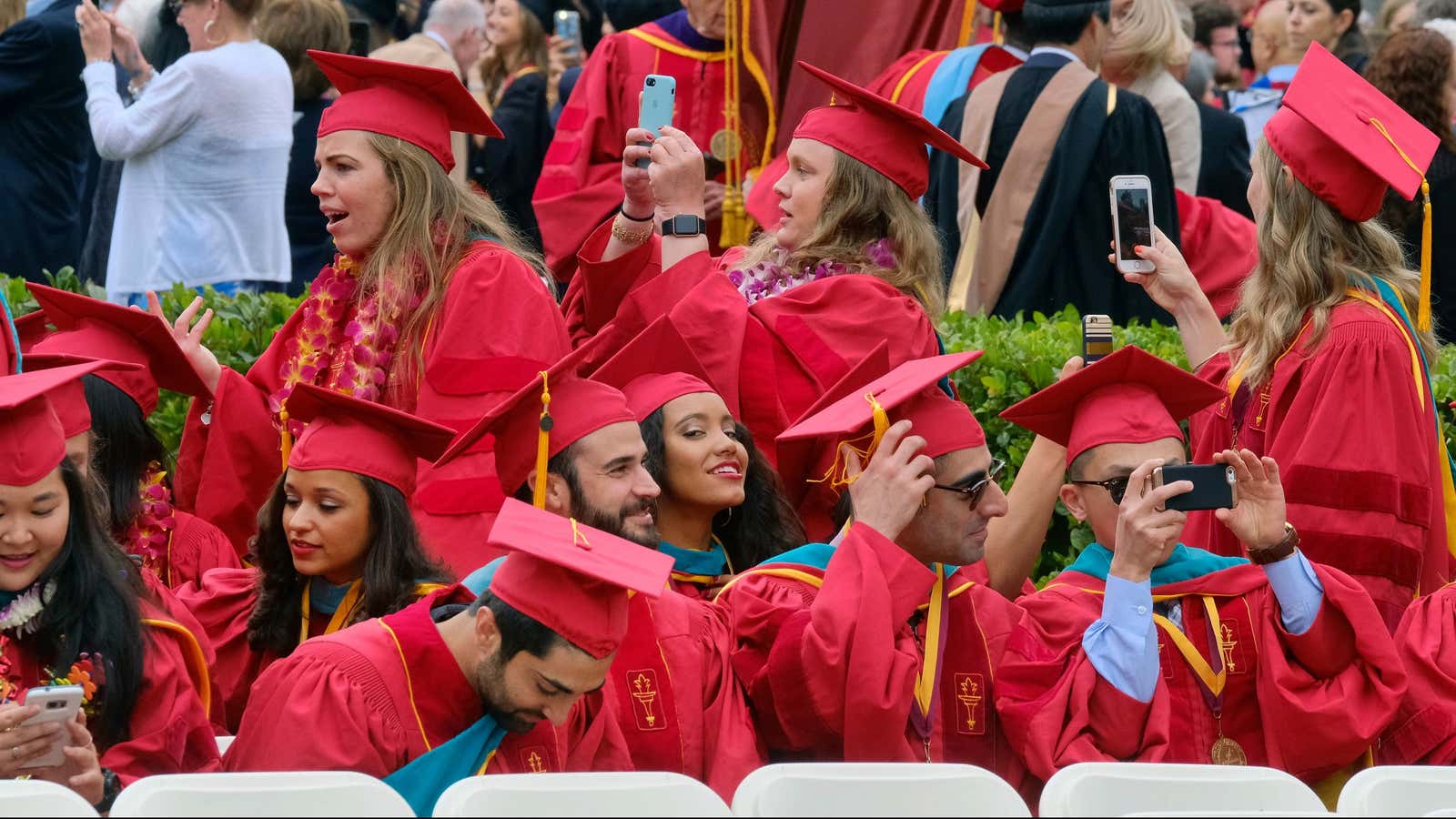 University of Southern California students take photos prior to the 134th commencement ceremony on the USC campus in Los Angeles on Friday, May 12, 2017. (AP Photo/Richard Vogel)