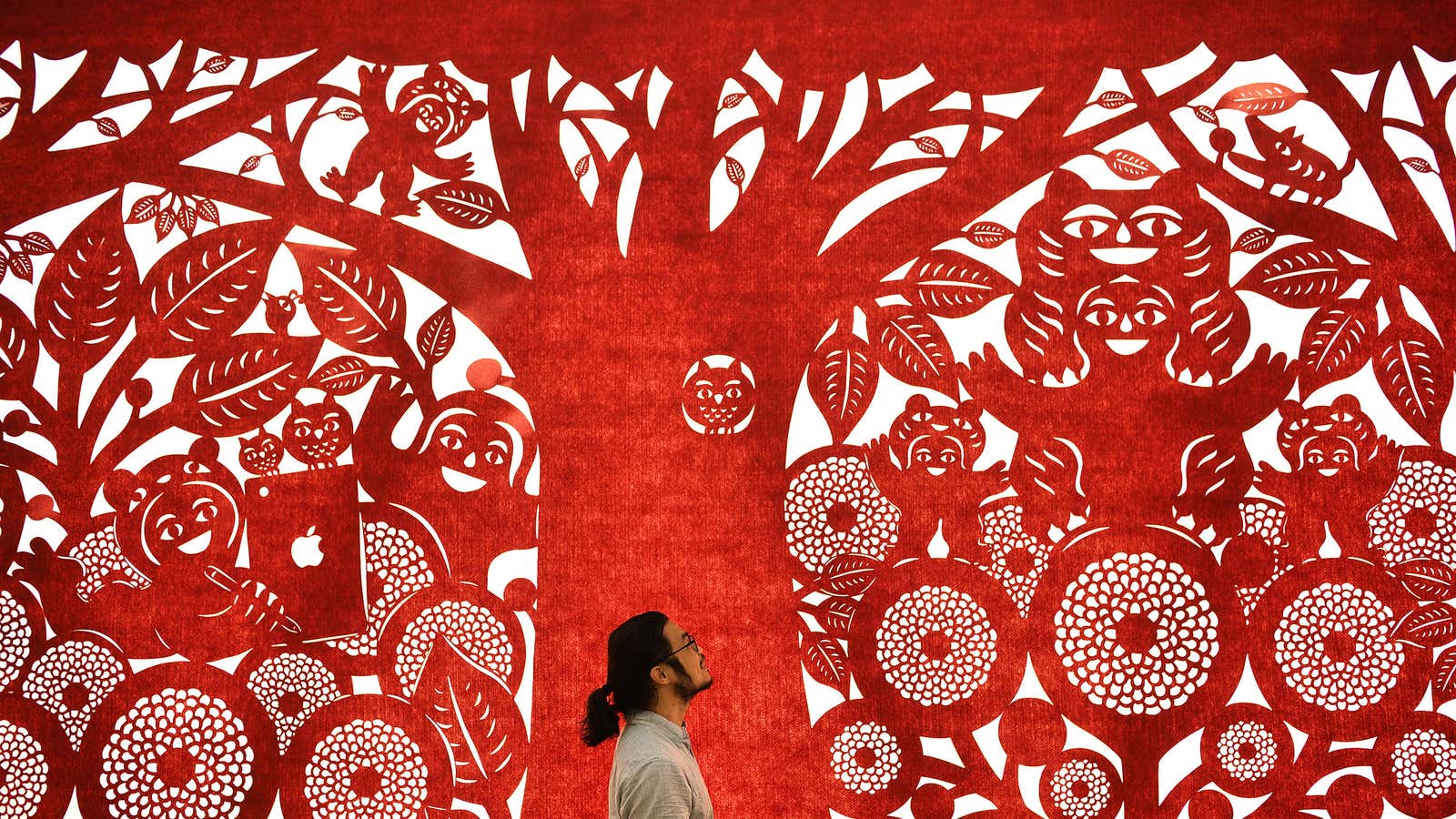 Apple is ringing in its next retail store with a 250-foot artwork painstakingly made with fabric and X-acto knives