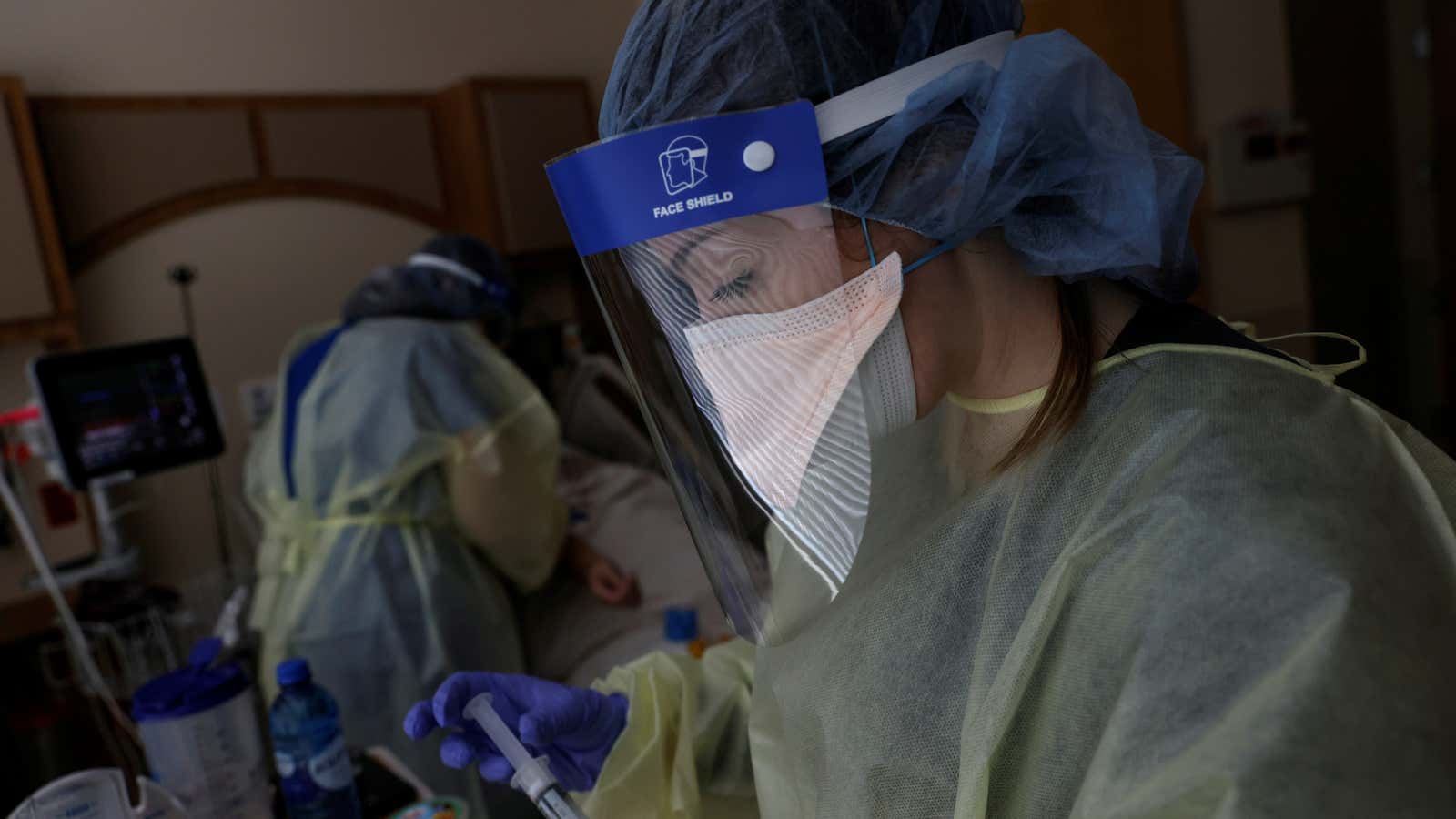 Registered Nurse Savanah Wagstaff and Aliza Burns, a nursing student at Brigham Young University–Idaho, treat a coronavirus disease (COVID-19) positive patient in her isolation room…