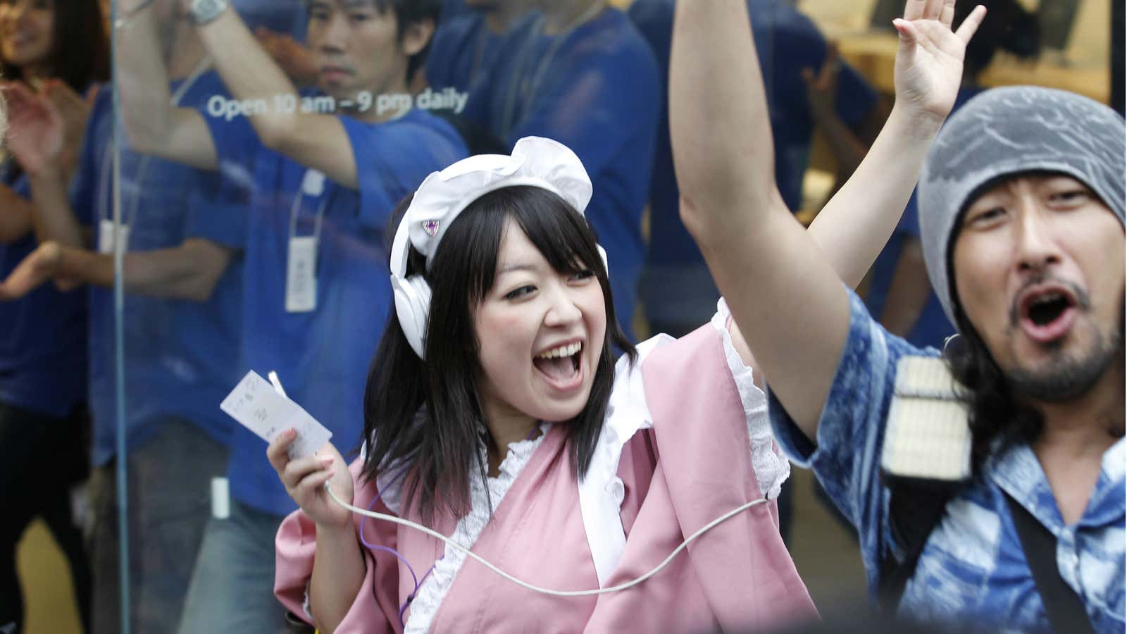 Customers celebrate the release of the iPhone 5 in Tokyo, Japan.