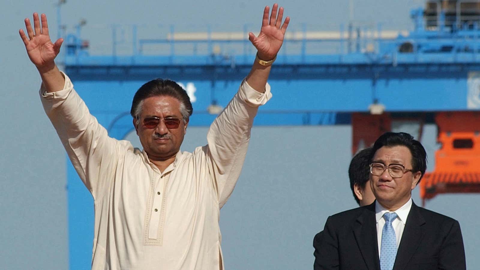 China’s communication minister stands quietly in the background while former Pakistani president Musharraf celebrates the opening of Gwardar Port.