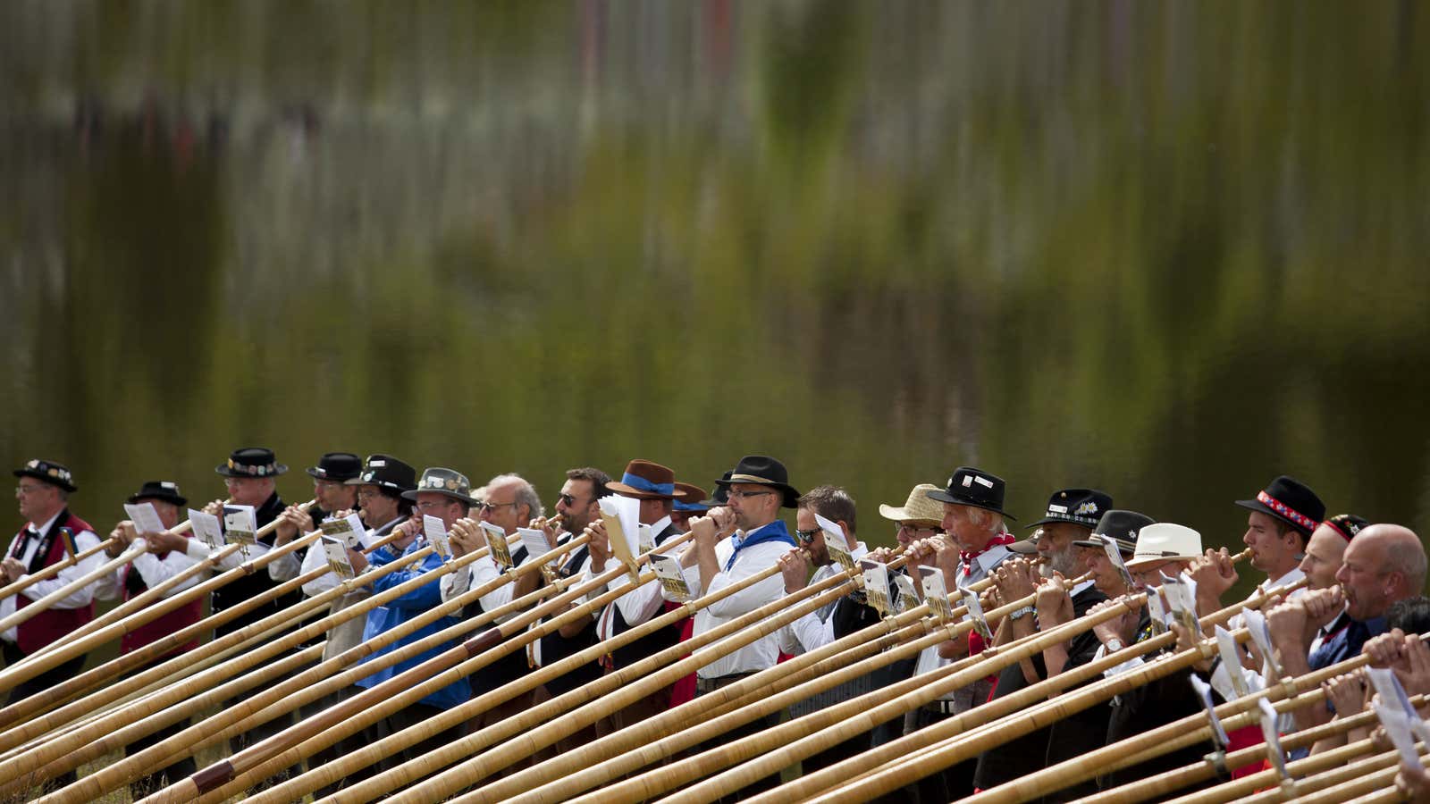 Alpenhorn players perform along the Lac de Tracouet.