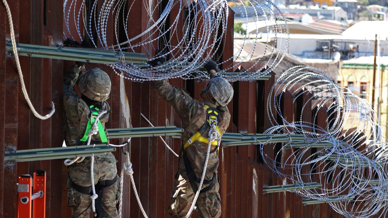 Troops begin installing concertina wire along the border fence in Nogales, AZ last November.