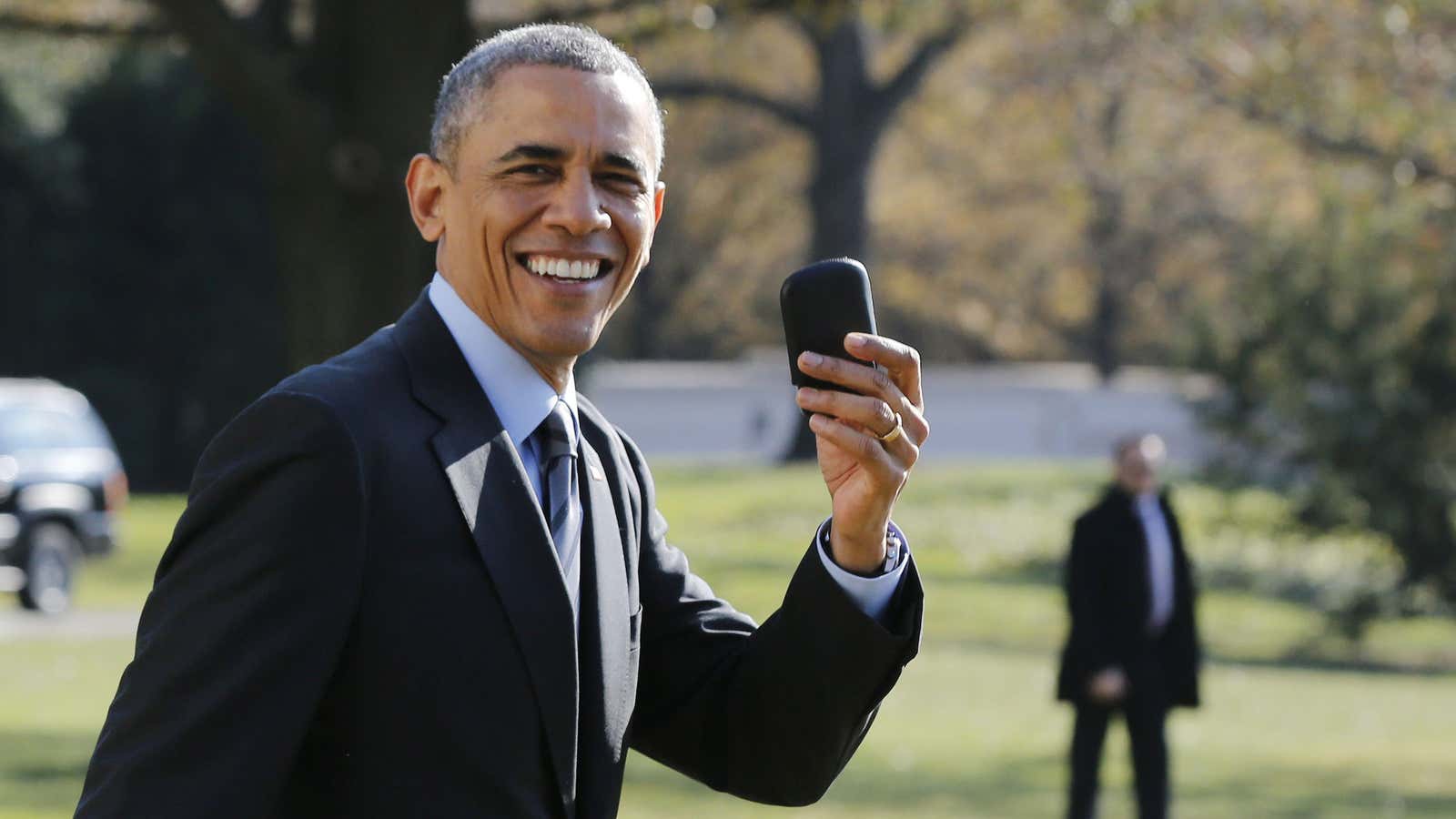 U.S. President Barack Obama holds up his BlackBerry device in 2014.