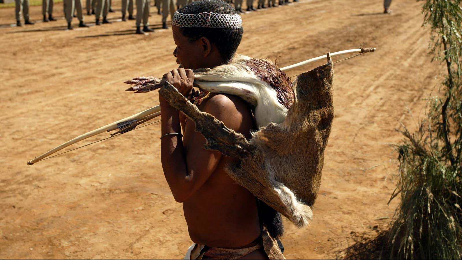A member of the San community demonstrates ancient hunting skills.