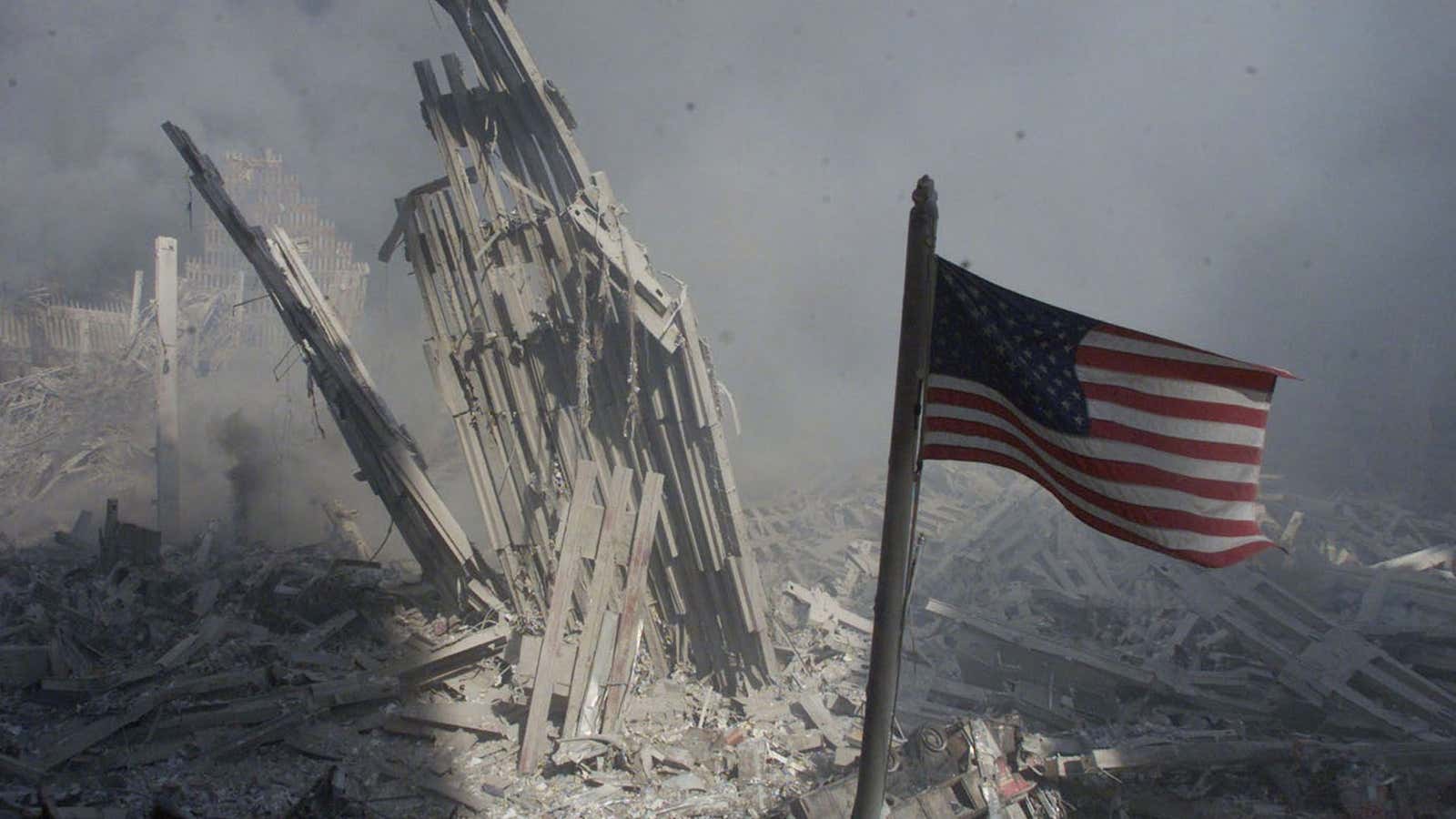 A flag at the base of the destroyed World Trade Center, on Sept. 11, 2001.