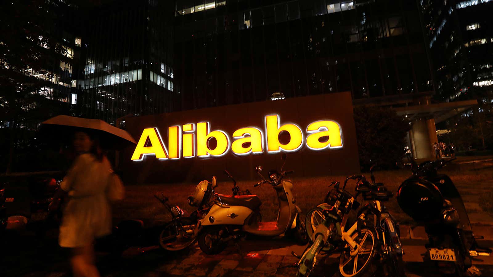 The logo of Alibaba Group is seen lit up at its office building in Beijing, China August 9, 2021. REUTERS/Tingshu Wang