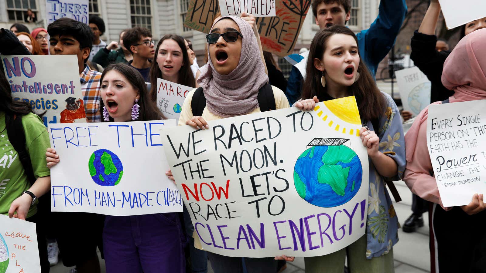 Students hold banners and placards during a demonstration against climate change in New York.