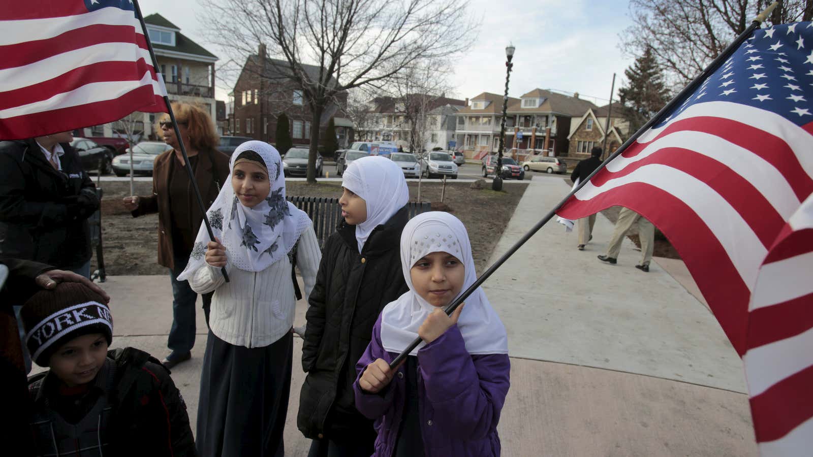Yemeni American Zohowr Al Masmari (R ) and her sister Gaiser hold American flags following a rally to protest against Islamic State and political and…