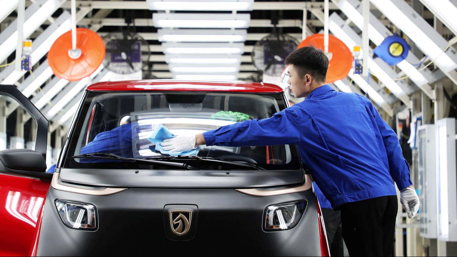Workers are seen at the assembly line of Baojun E200 electric vehicles (EV) at a plant of SAIC-GM-Wuling, a joint venture among SAIC Motor, General Motors and Liuzhou Wuling Motors Co Ltd, in Qingdao, Shandong province China September 28, 2018.