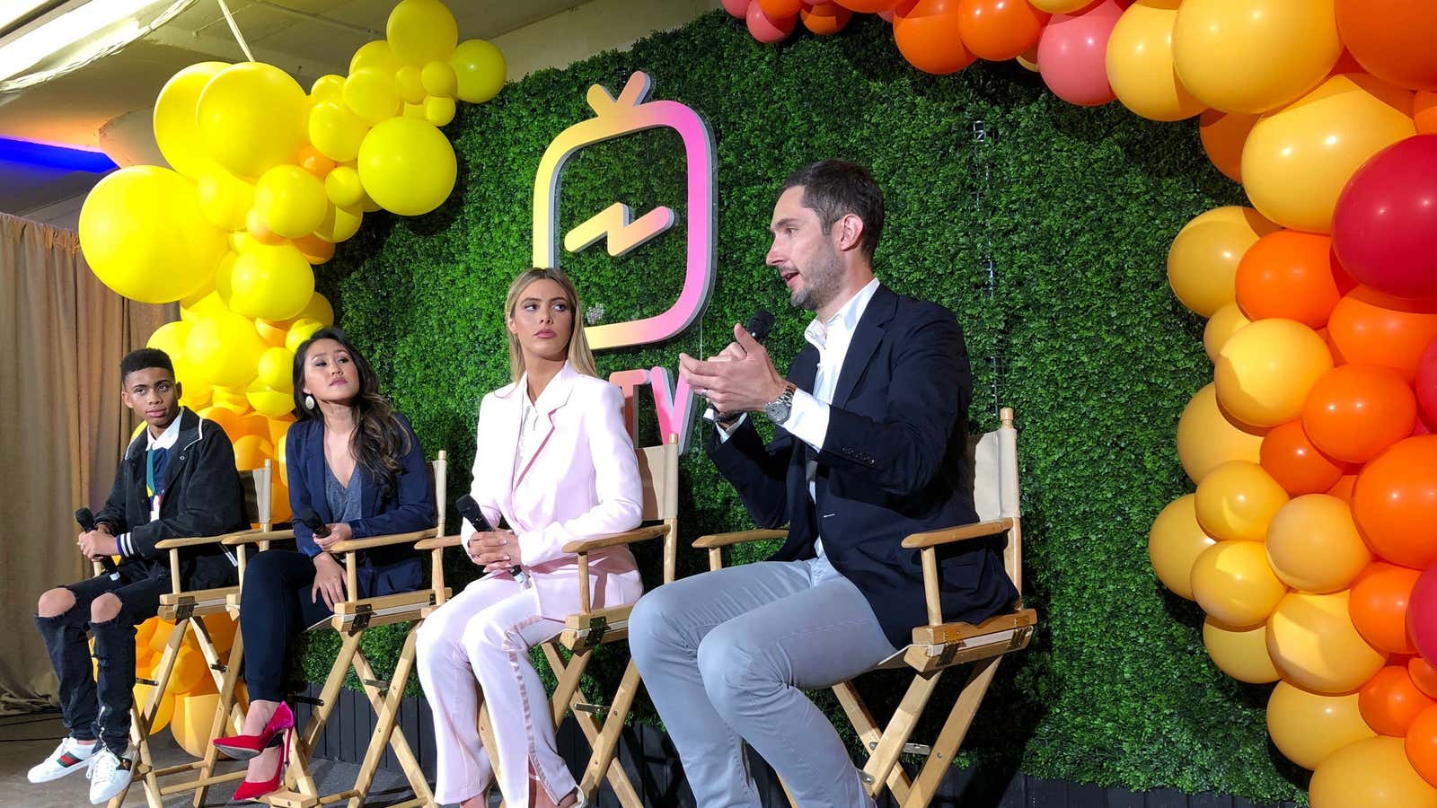 Instagram Chief Executive Kevin Systrom, right, answers a question at a news conference June 20, 2018.