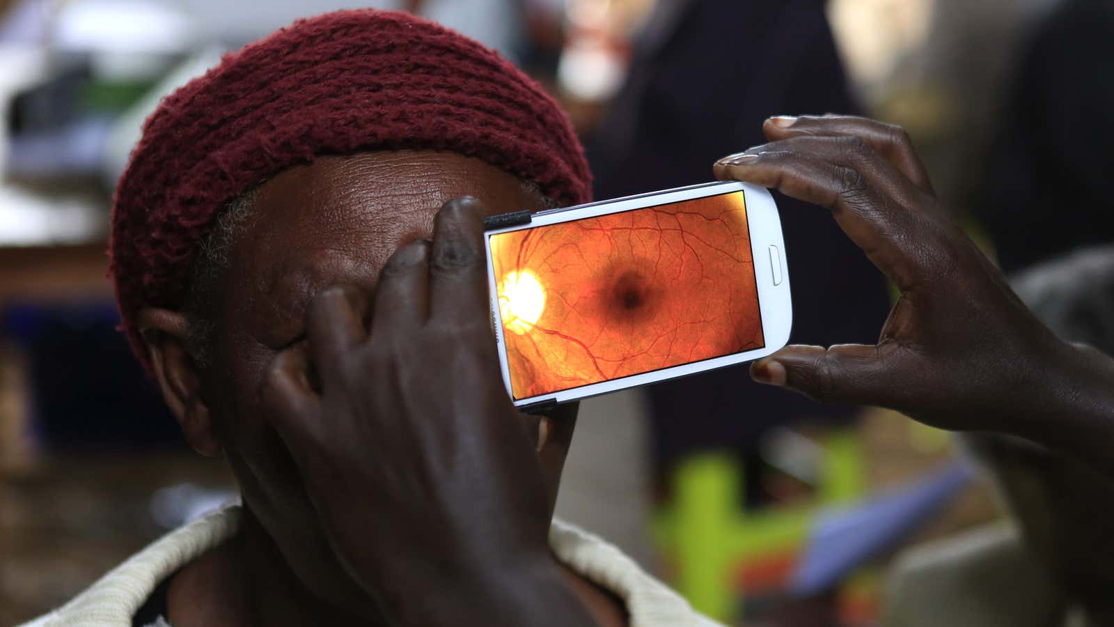 A woman undergoes an eye examination using of a smartphone at a clinic in Kenya.