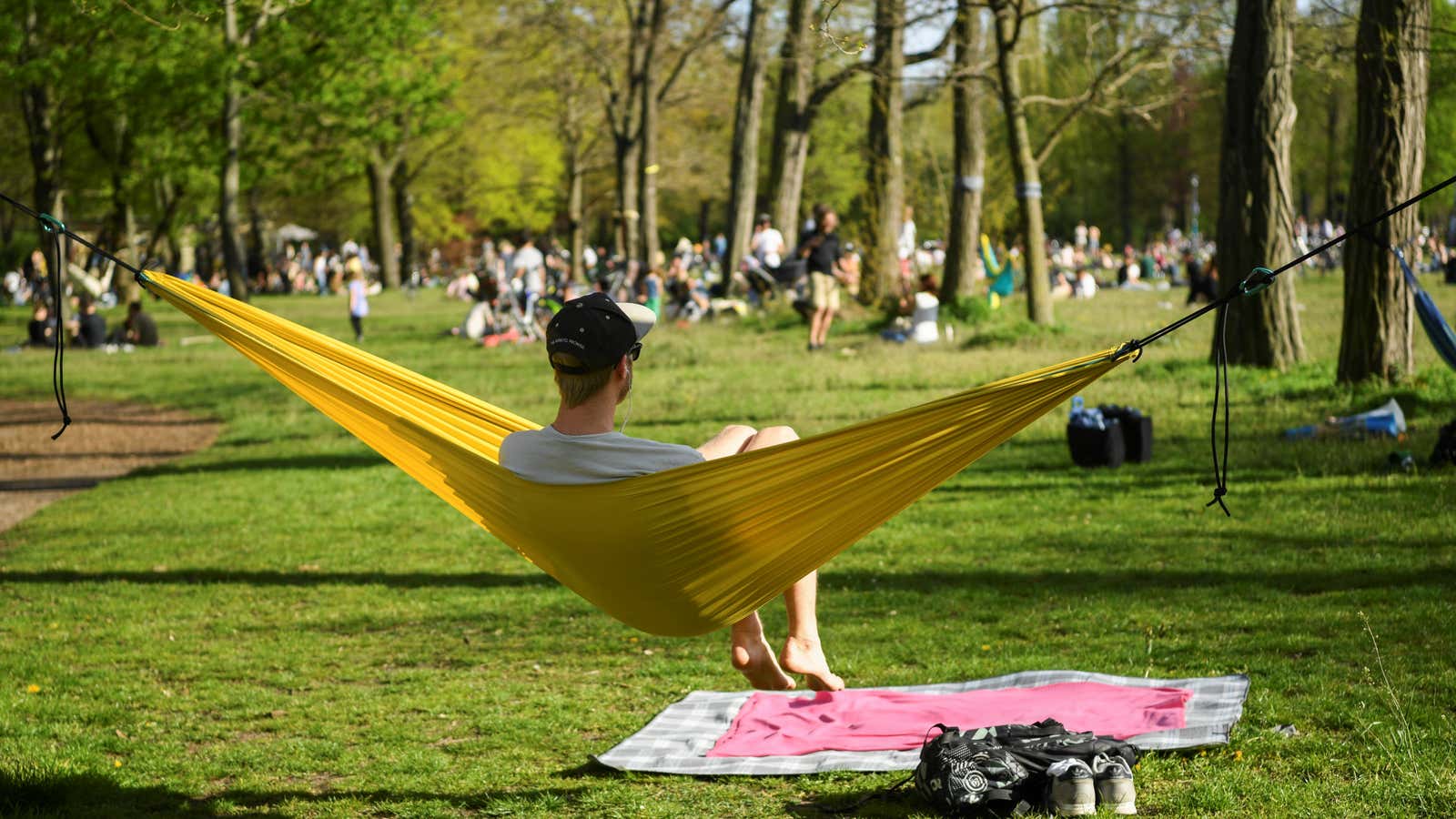 A man relaxes in a hammock as he enjoys the sunny weather in Volkspark Friedrichshain, as the spread of the coronavirus disease (COVID-19) continues, in Berlin, Germany, May 9, 2021. REUTERS/Annegret Hilse