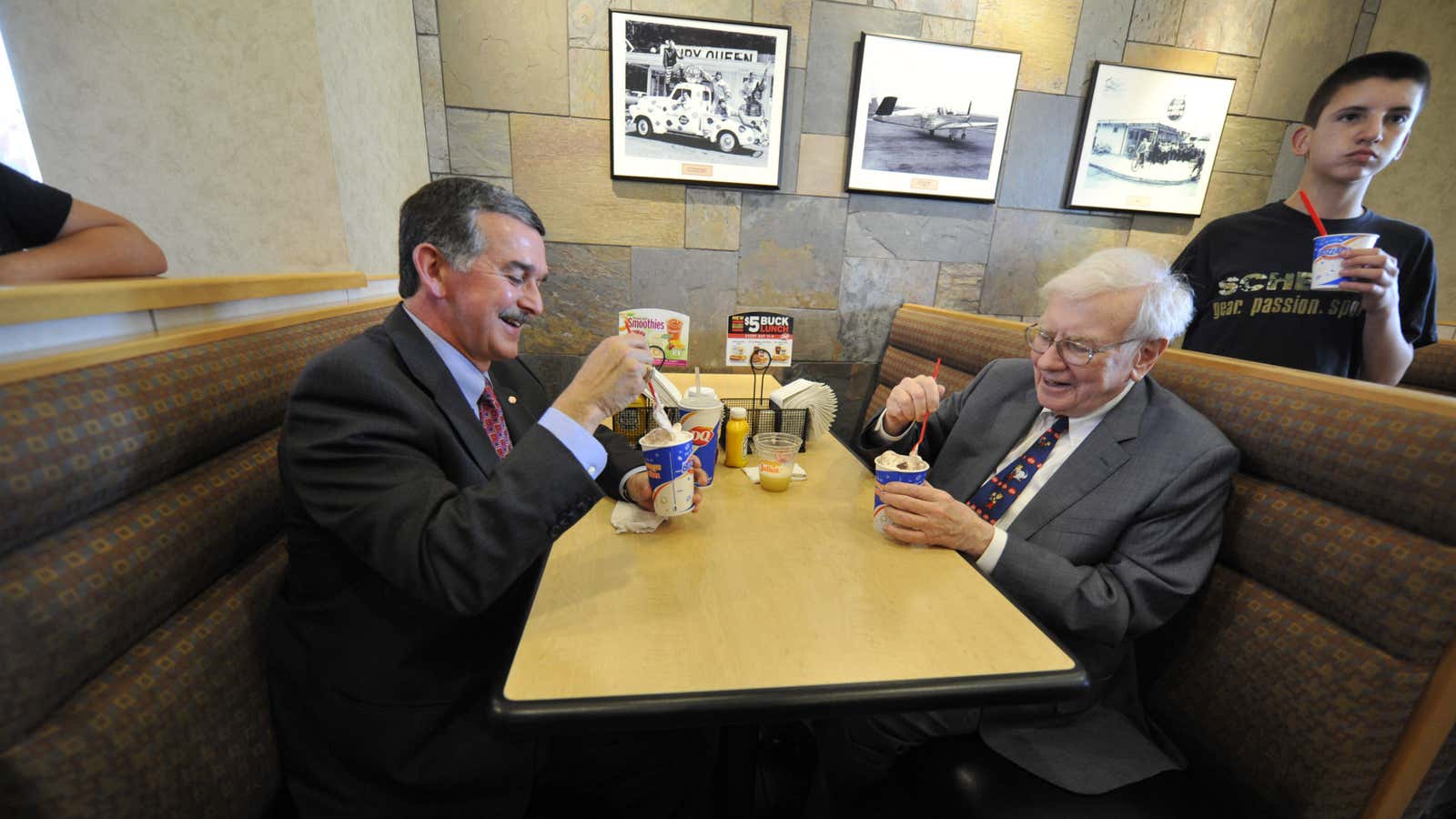 Warren Buffett enjoys an ice cream while his team of managers handle business back at Berkshire Hathaway headquarters.
