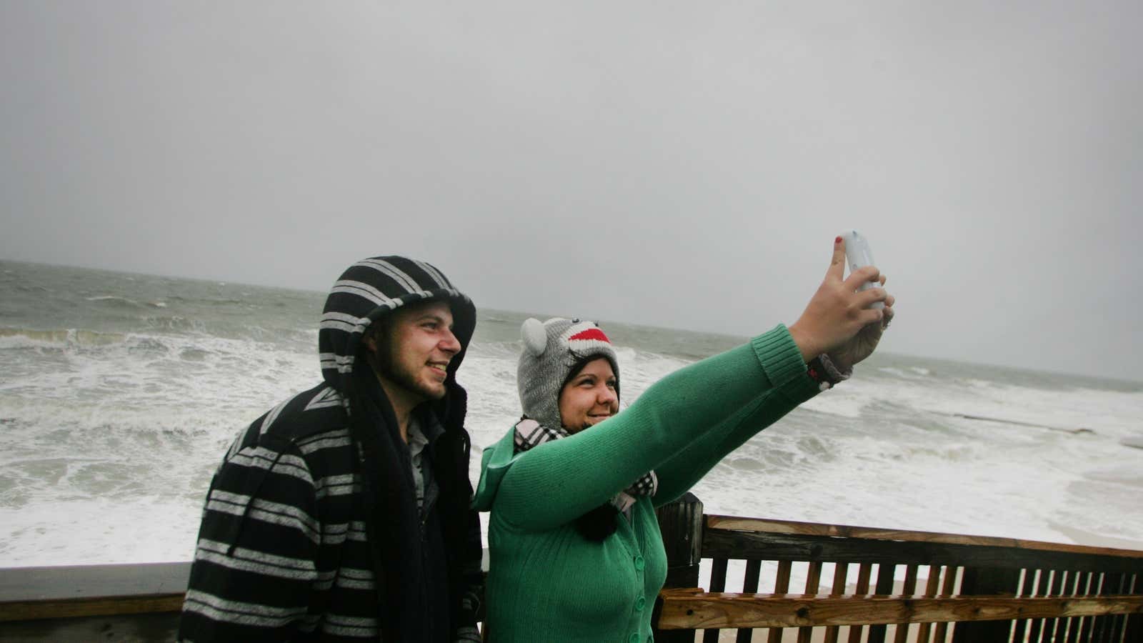 Newlyweds Lisa and Michael Chamberlain snap pictures in front of Hurricane Sandy’s advancing storm surge on Oct. 28.