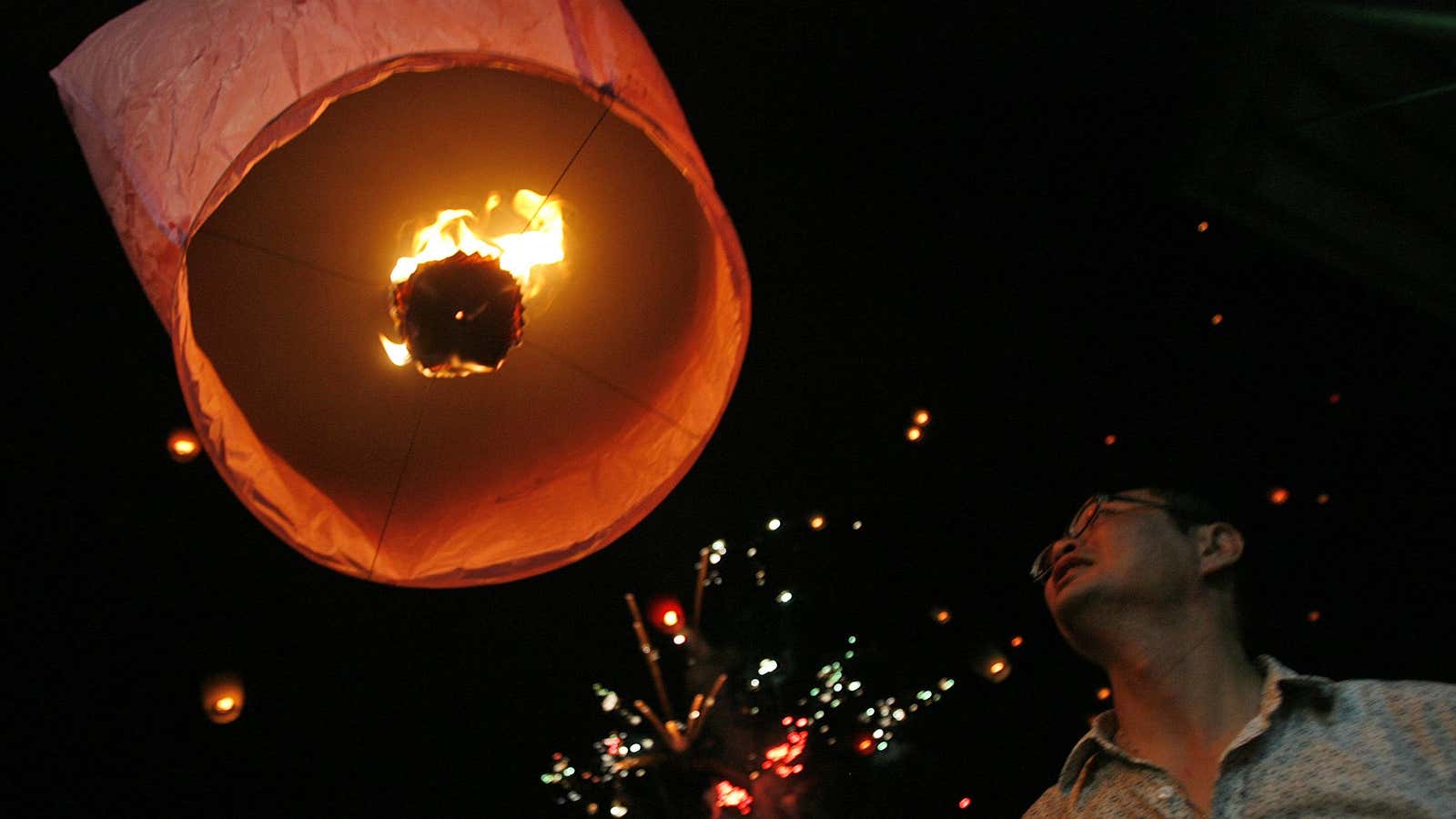 A man releases a lantern during Chinese Valentine’s Day or “Qi Xi” festivities in Shifen,Taiwan.