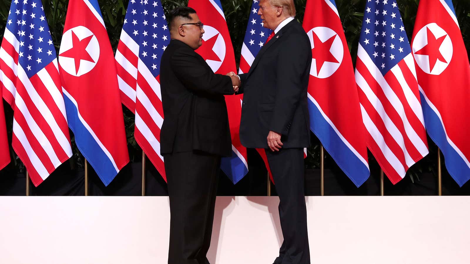Donald Trump and Kim Jong Un shake hands in Singapore.