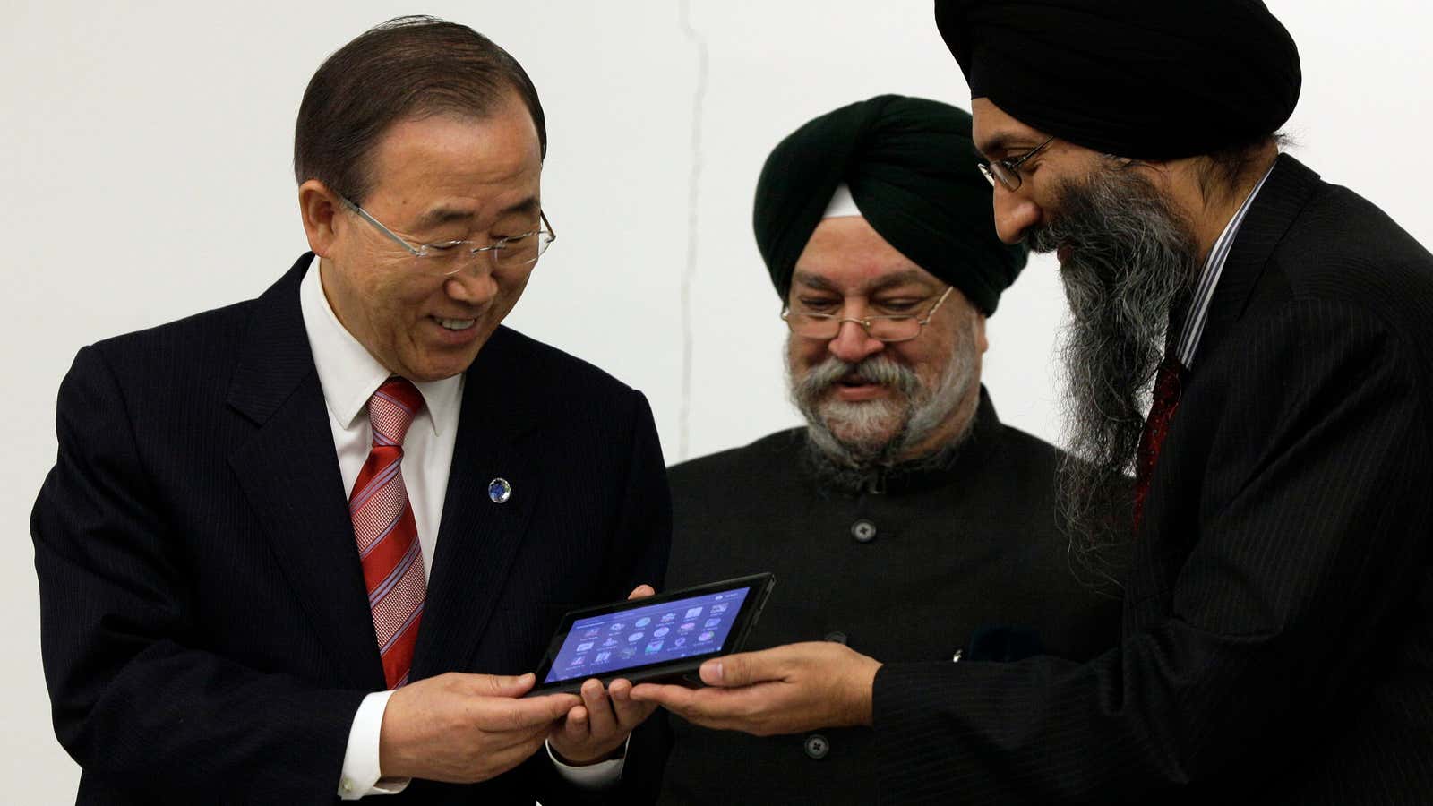 UN Secretary General Ban Ki-moon, left, receives an Aakash 2 tablet computer from Suneet Tuli, right, CEO of Datawind, and India’s UN Ambassador Hardeep Singh Puri. (Nov. 28, 2012)
