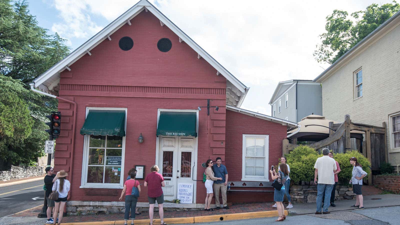 Passersby gather to take photos in front of the Red Hen Restaurant, Saturday, June 23, 2018.