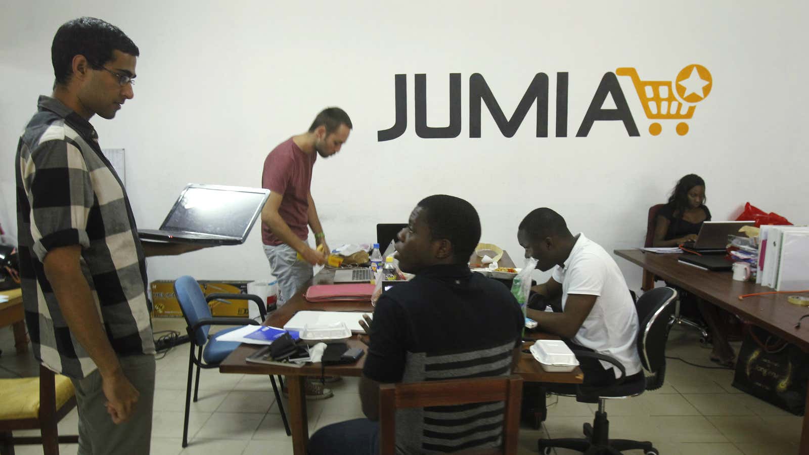 Employees work at the production hall of Jumia office in Abidjan December 17, 2014.