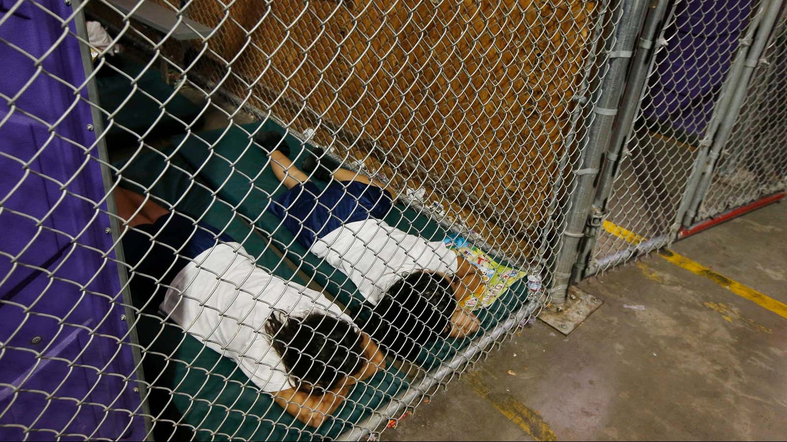 Immigrant girls sleep in a cell, Jun. 18, 2014.
