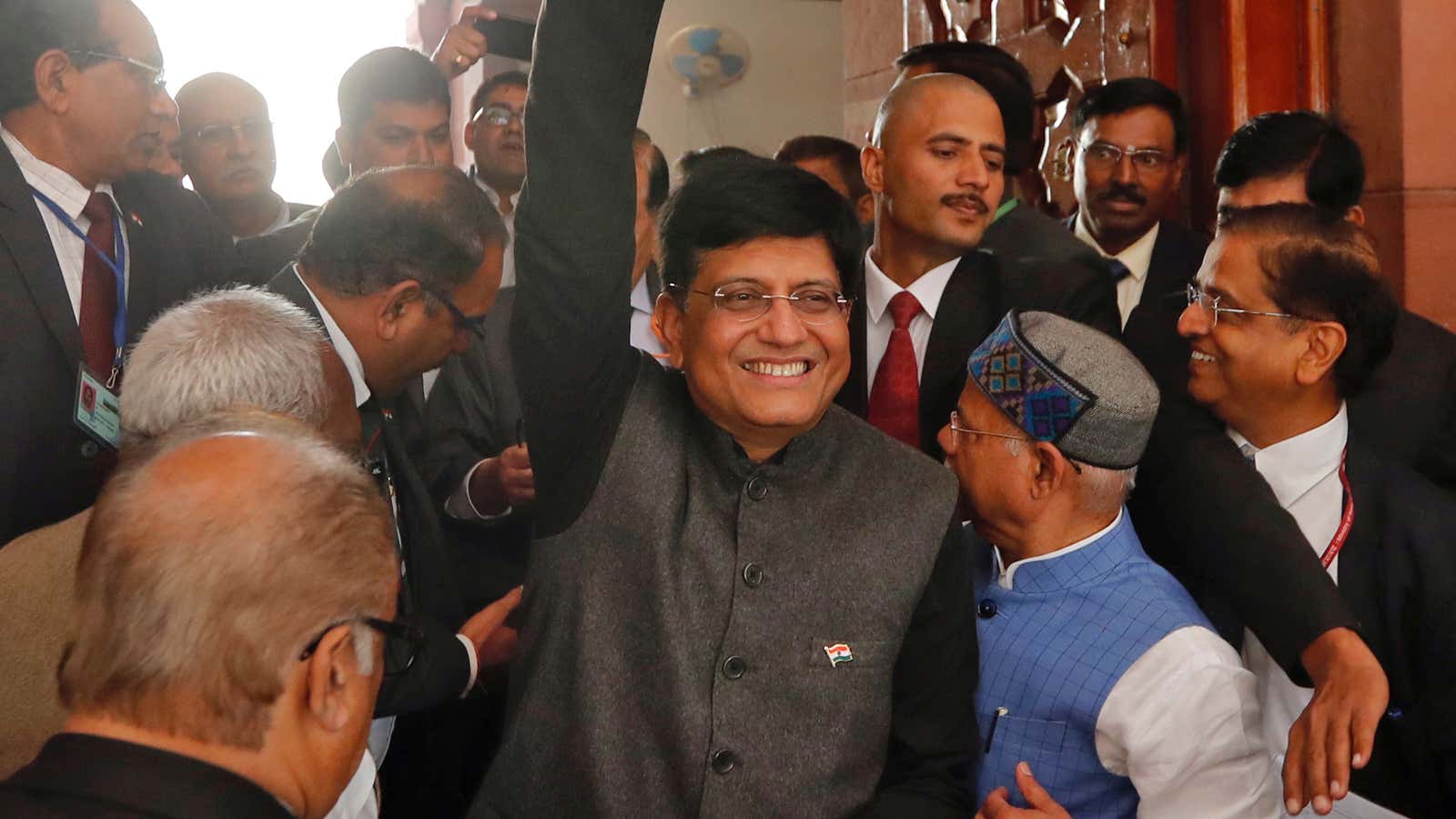 India’s interim Finance Minister Piyush Goyal waves as he holds his briefcase upon arrives at the parliament to present 2019-20 budget in New Delhi, India,…