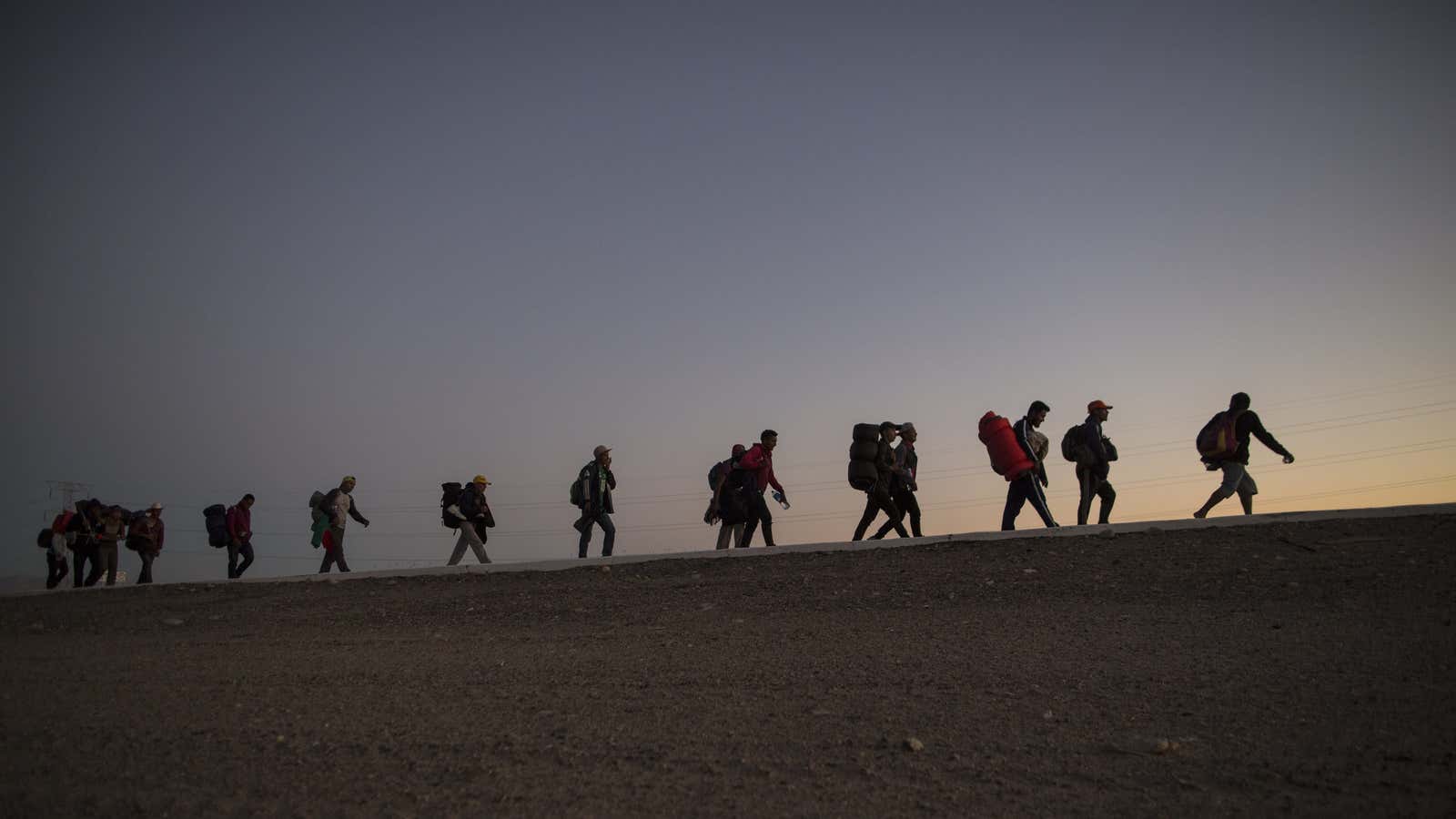 People who fled Central America walking toward the US border.