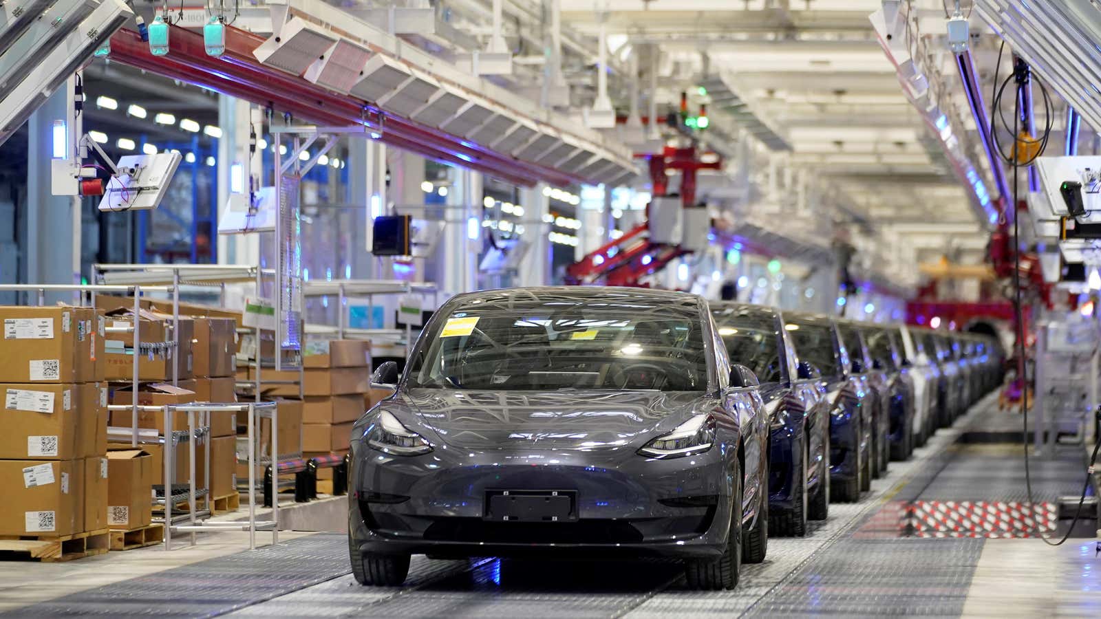 A line of Tesla Model 3 cars rolls out of the Shanghai Gigafactory.