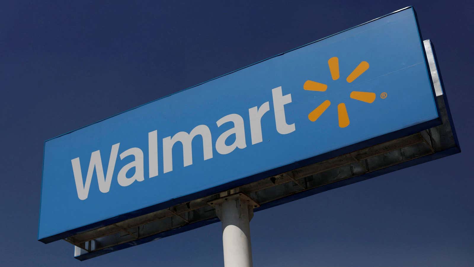 A billboard displays the Walmart logo.