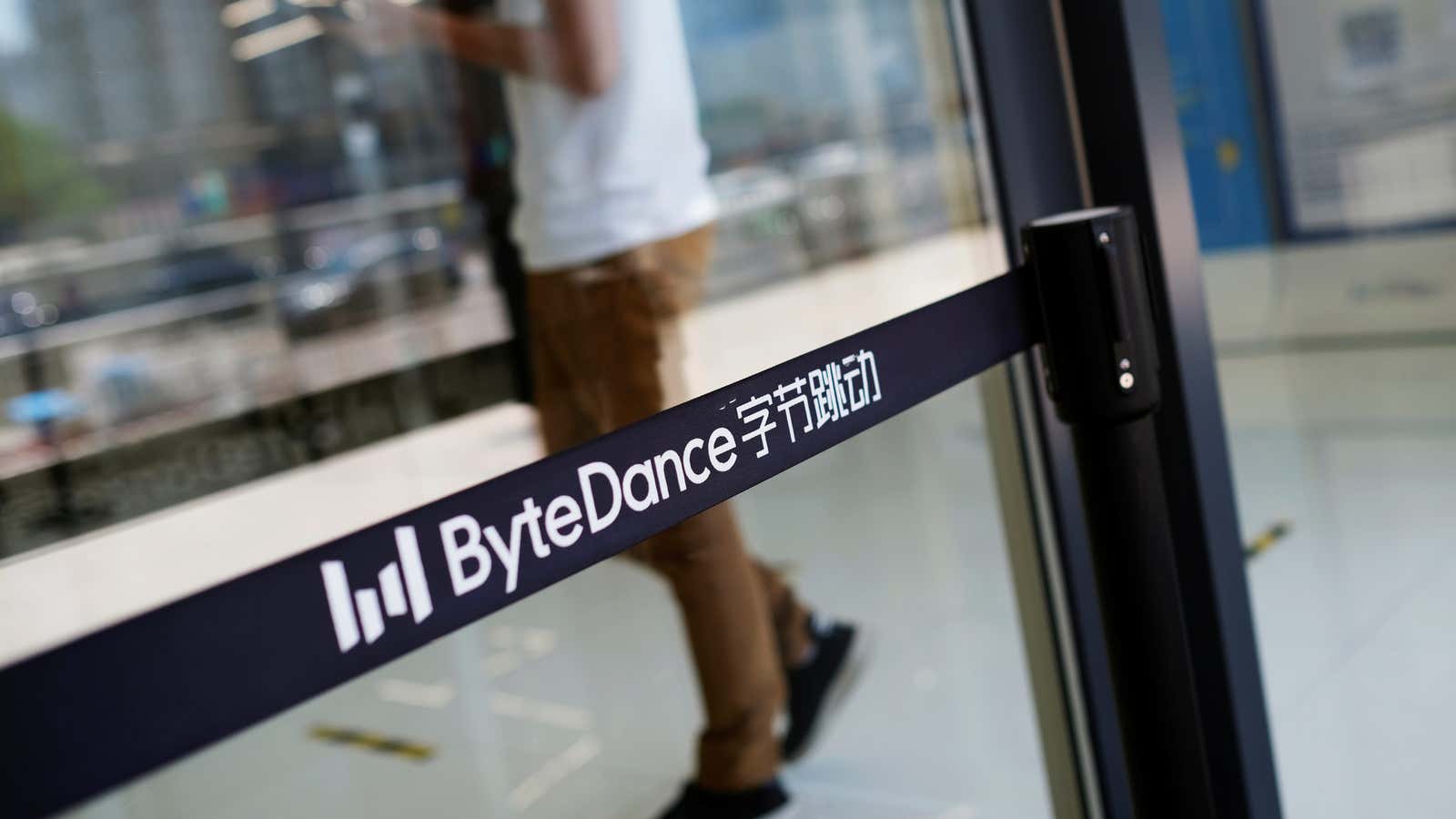 A man walks by a logo of Bytedance, the China-based company which owns the short video app TikTok, or Douyin, at its office in Beijing,…