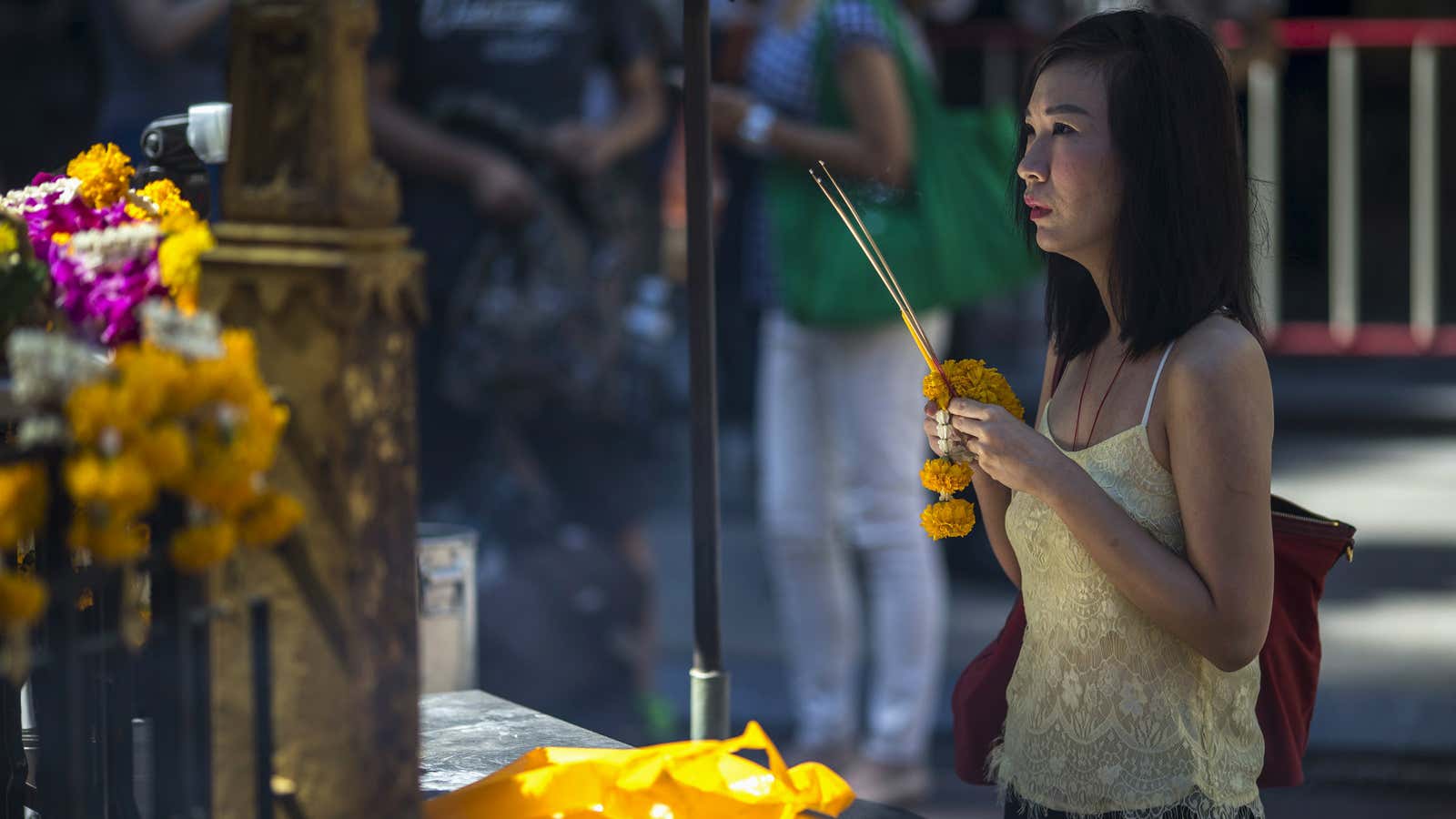 A woman prays at the Erawan shrine that was targeted in the Aug. 17 bombing.