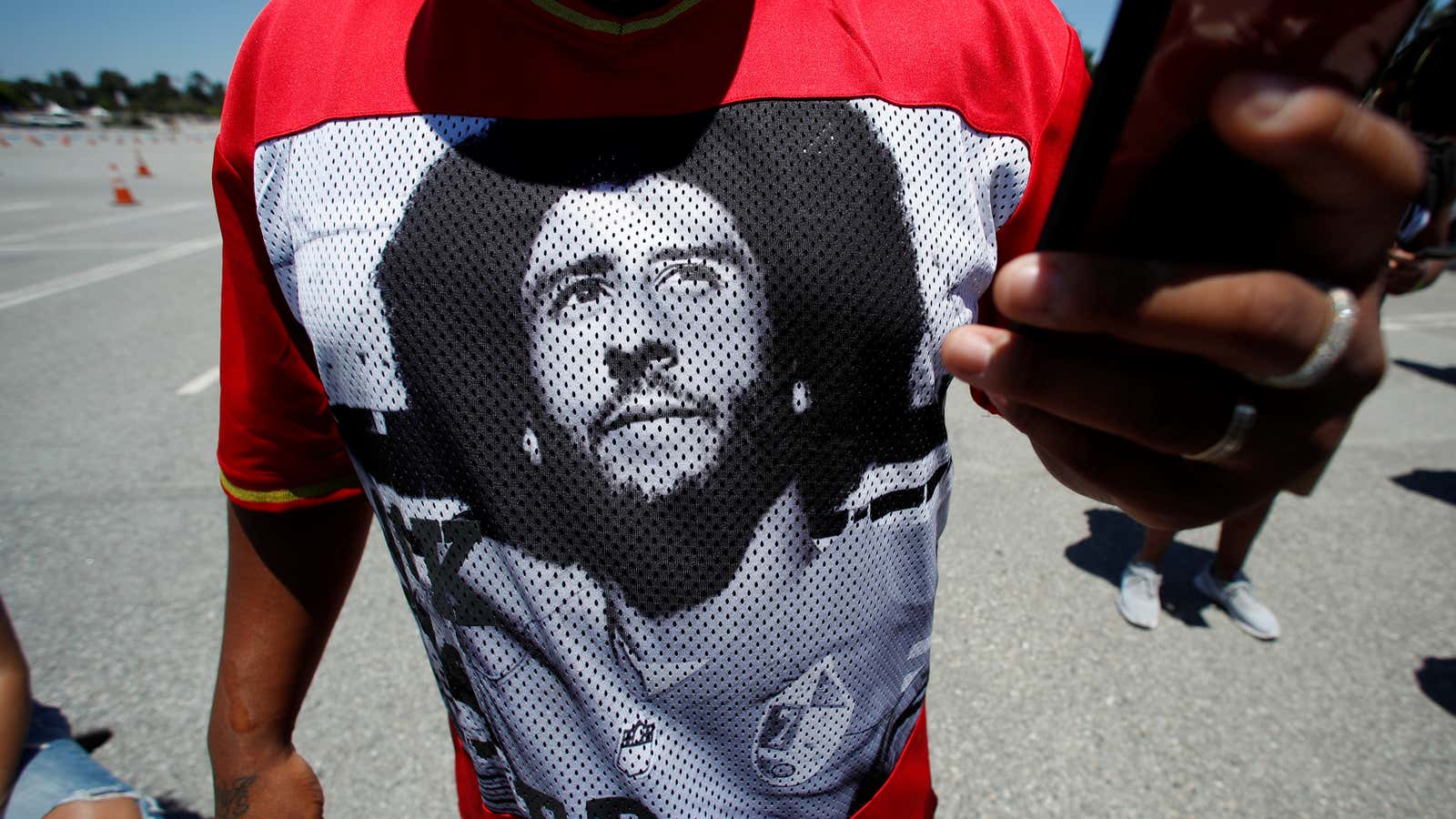 A protester wears a t-shirt with a picture of Colin Kaepernick during a protest against police brutality and racial inequality in the aftermath of theâ€¦